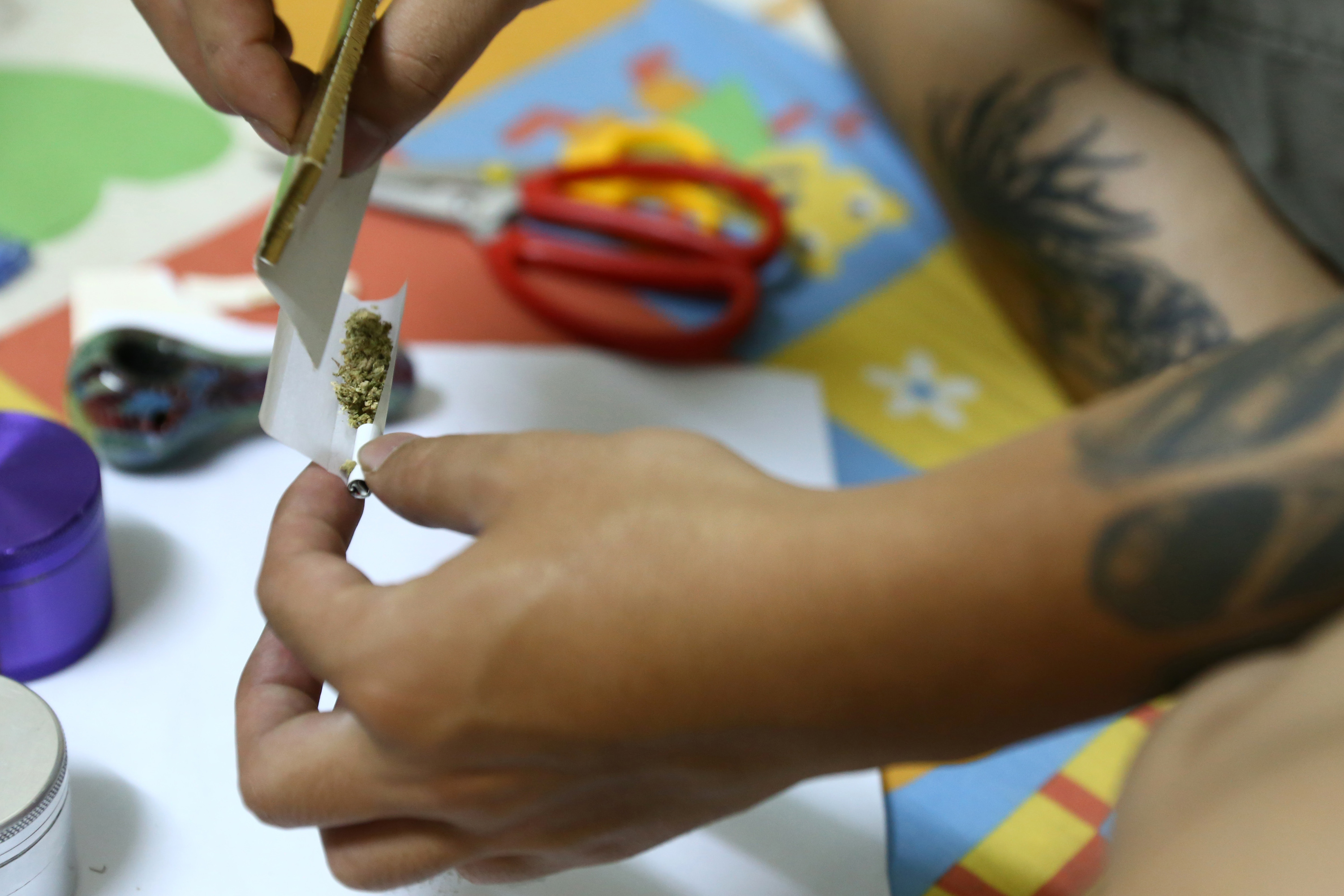 A man rolls a joint with Canadian-grown marijuana at his room in the old quarter area of Hanoi. Photo: AP