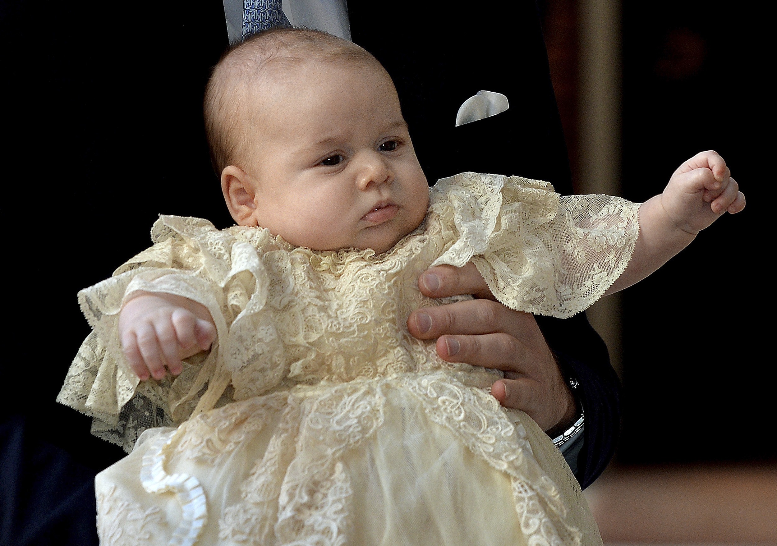 Britain's Prince William carries his son Prince George as they arrive for his son's christening at St James's Palace in London Photo: REUTERS