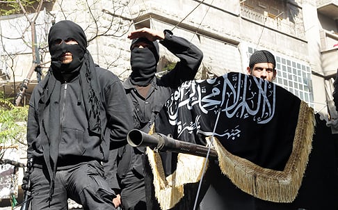 Al-Nusra Front fighters take part in a parade calling for the establishment of an Islamic state in Syria. Photo: AFP