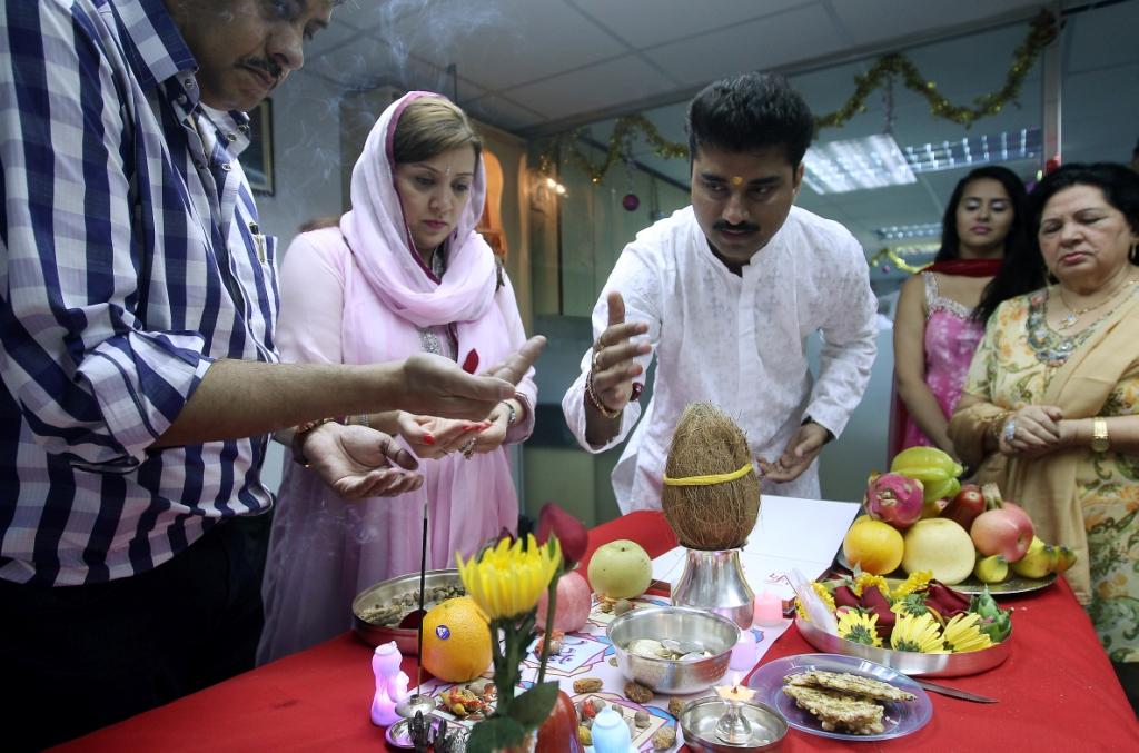 A family joins in Diwali prayers. Photo: Jonathan Wong
