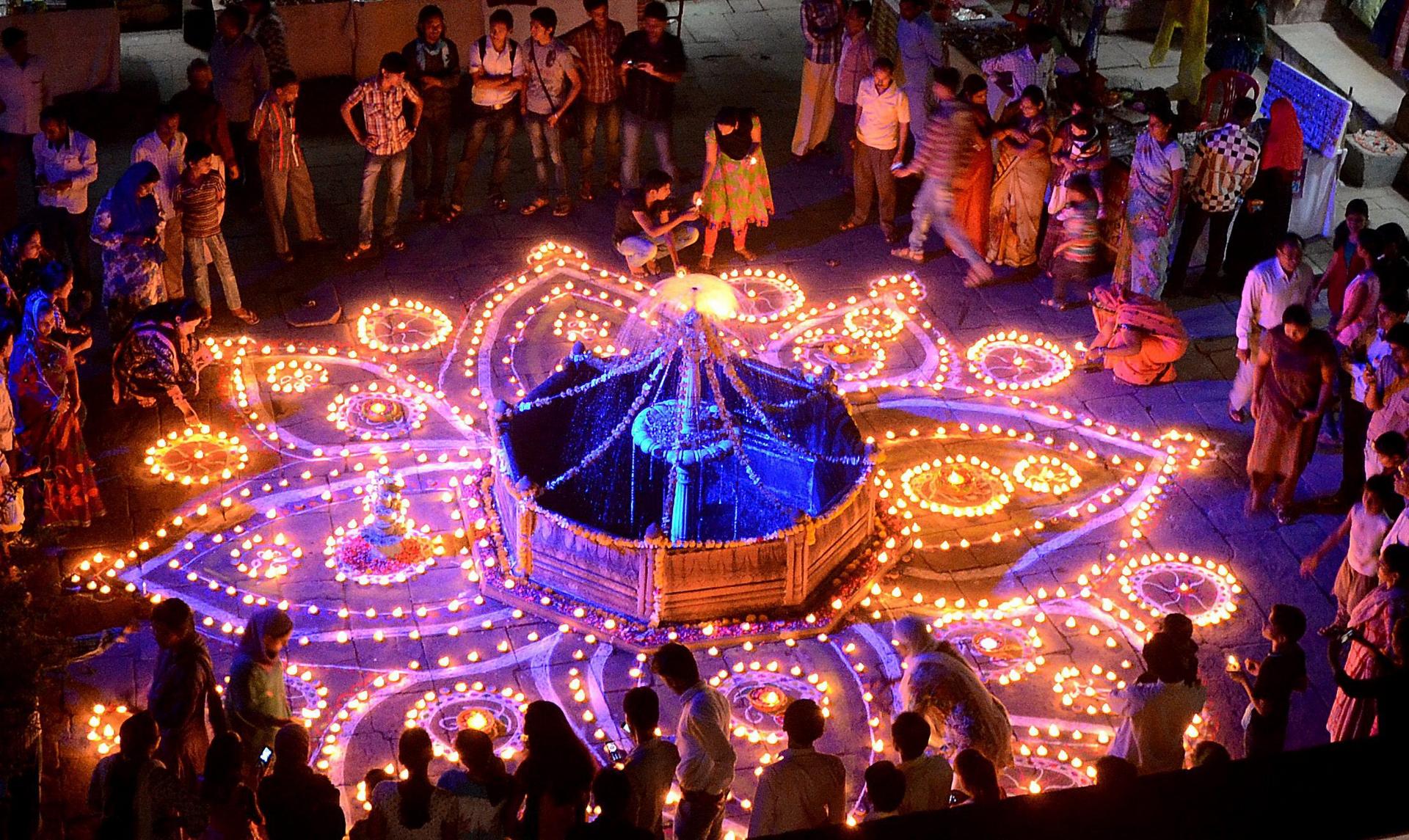 Hindu devotees light oil lamps for the festival at Gohar Mahal. Photo: EPA
