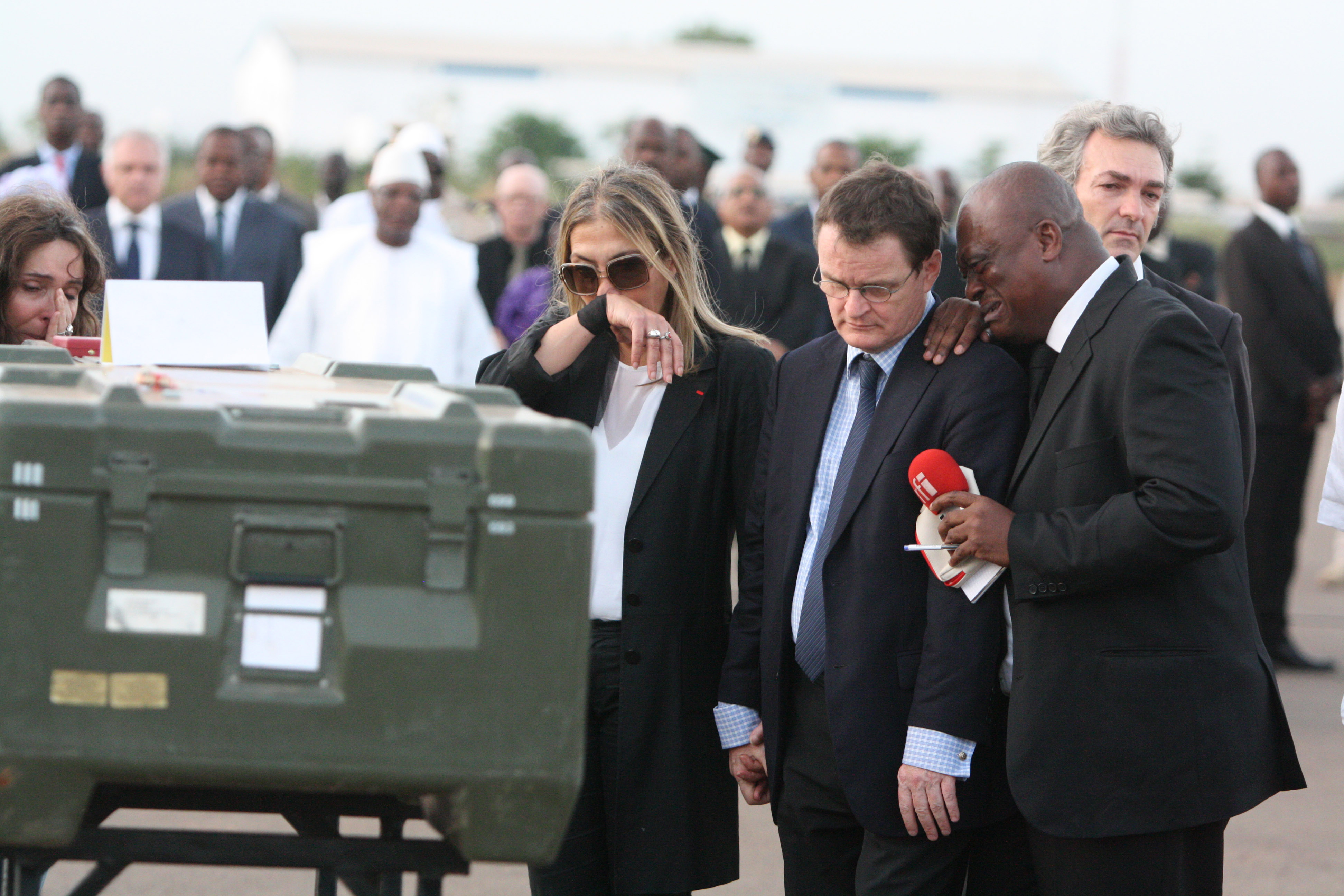 Marie-Christine Saragosse, third right, president of France Medias Monde and Serge Daniel, right, Radio France Internationale's Mali correspondent, weep as they pay their respects. Photo: AP