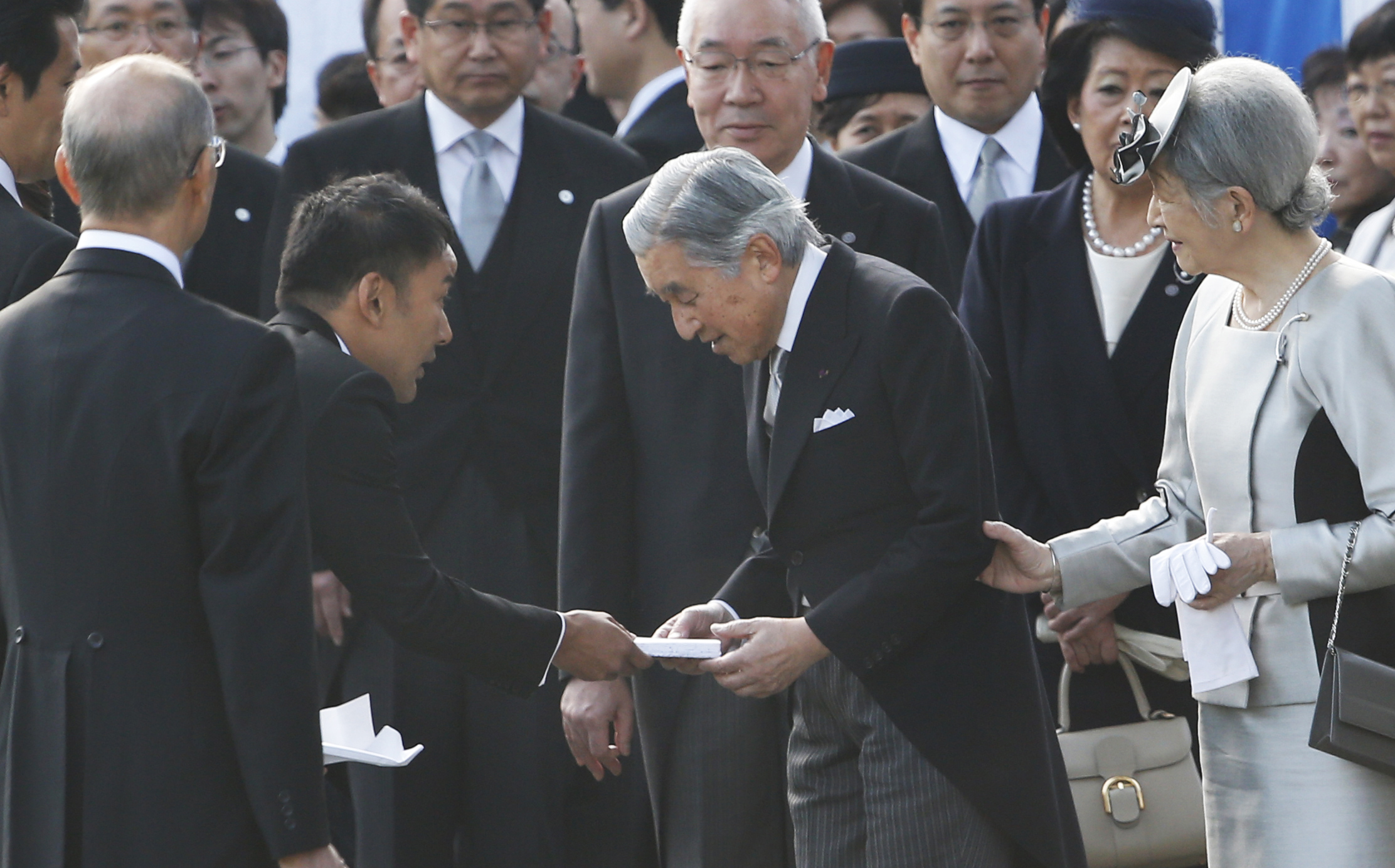 Actor-turned-lawmaker Taro Yamamoto, second left, hands over a letter to Japan's Emperor Akihito, second right. Photo: AP
