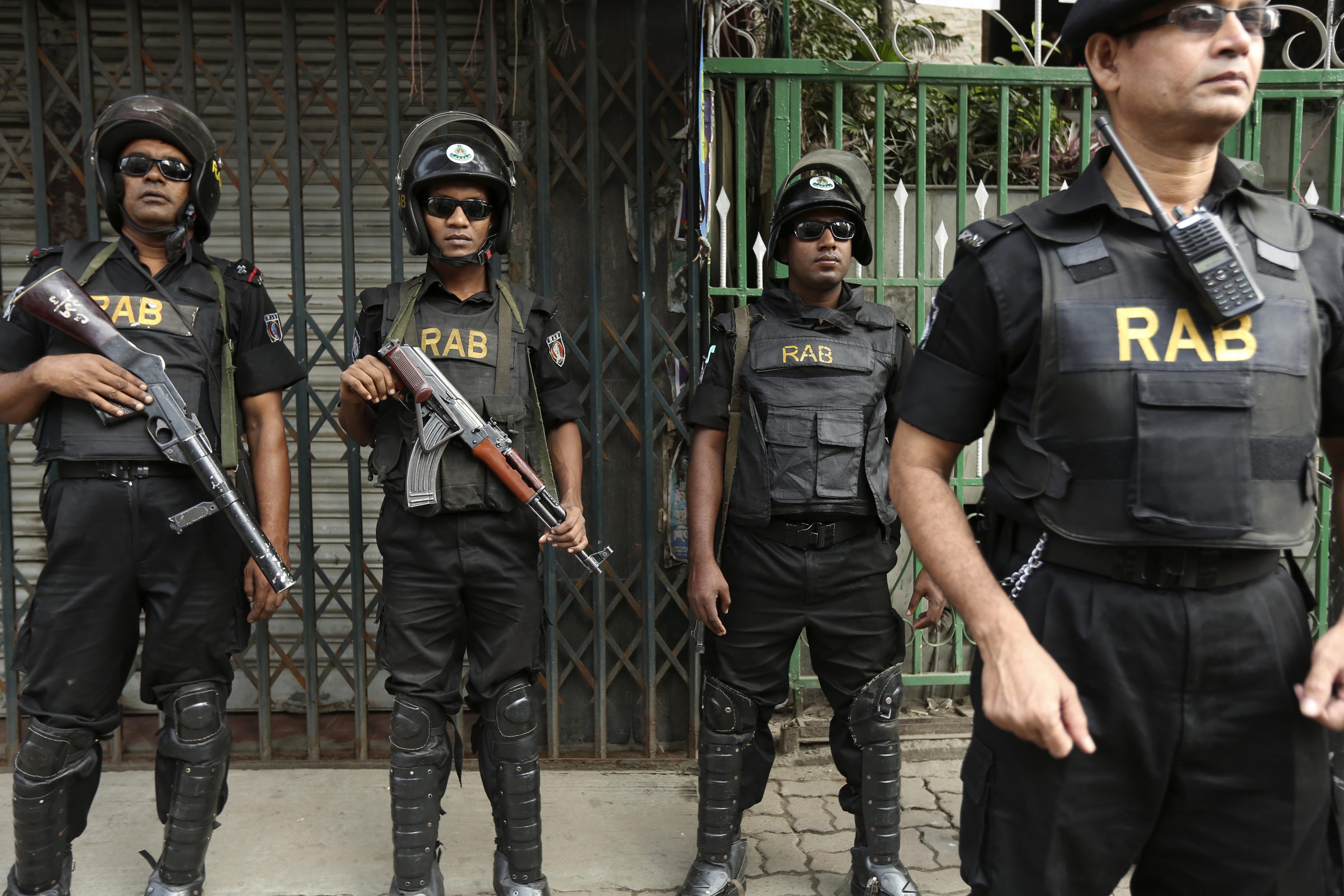 Members of the elite force Rapid Action Battalion stand guard in the streets during the the first day of the 60-hour countrywide shutdown called by the Bangladesh Nationalist Party in Dhaka. Photo: EPA