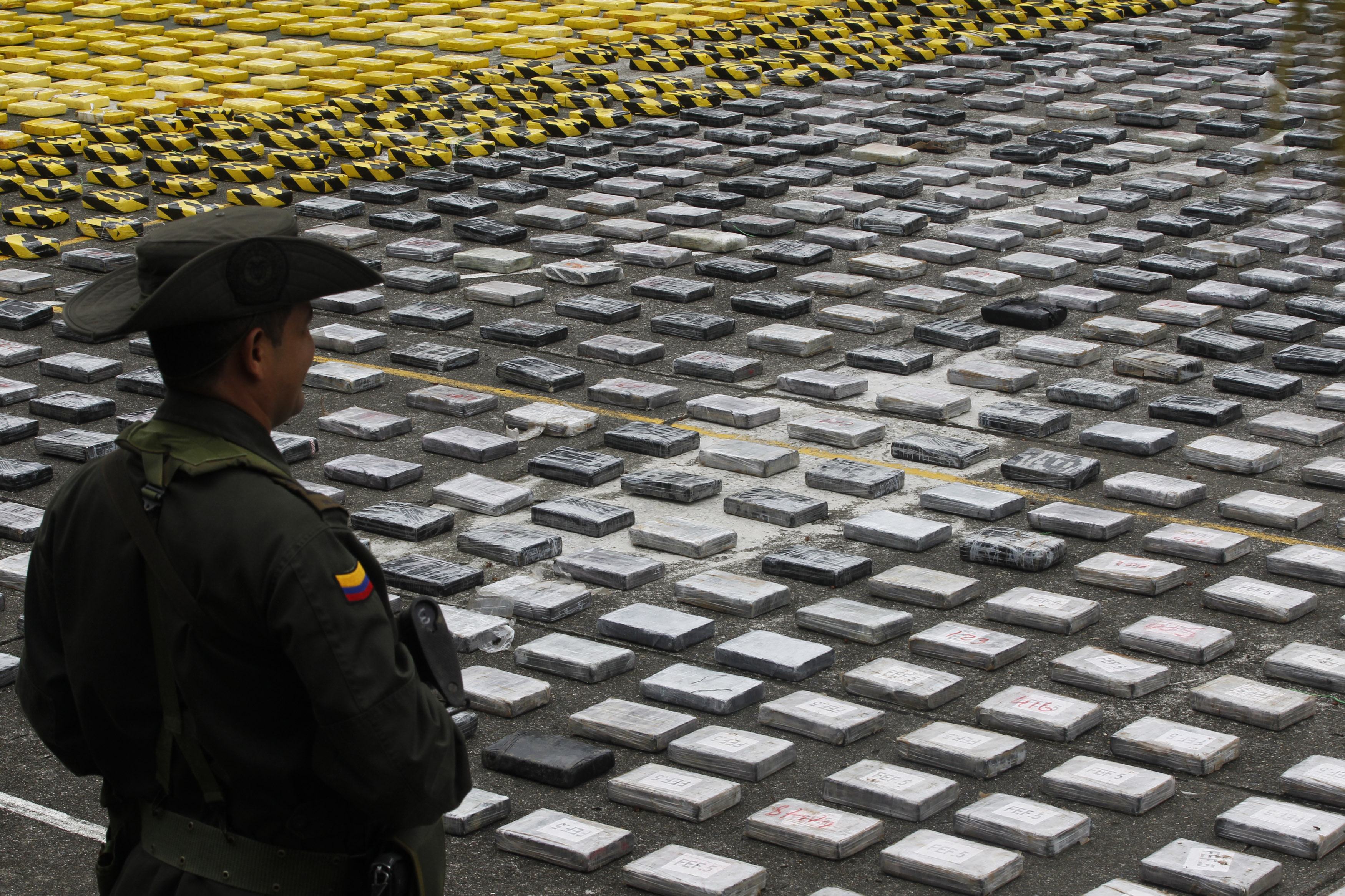 An anti-narcotics policeman guards seized packs of cocaine at a military base in Colombia. Photo: Reuters