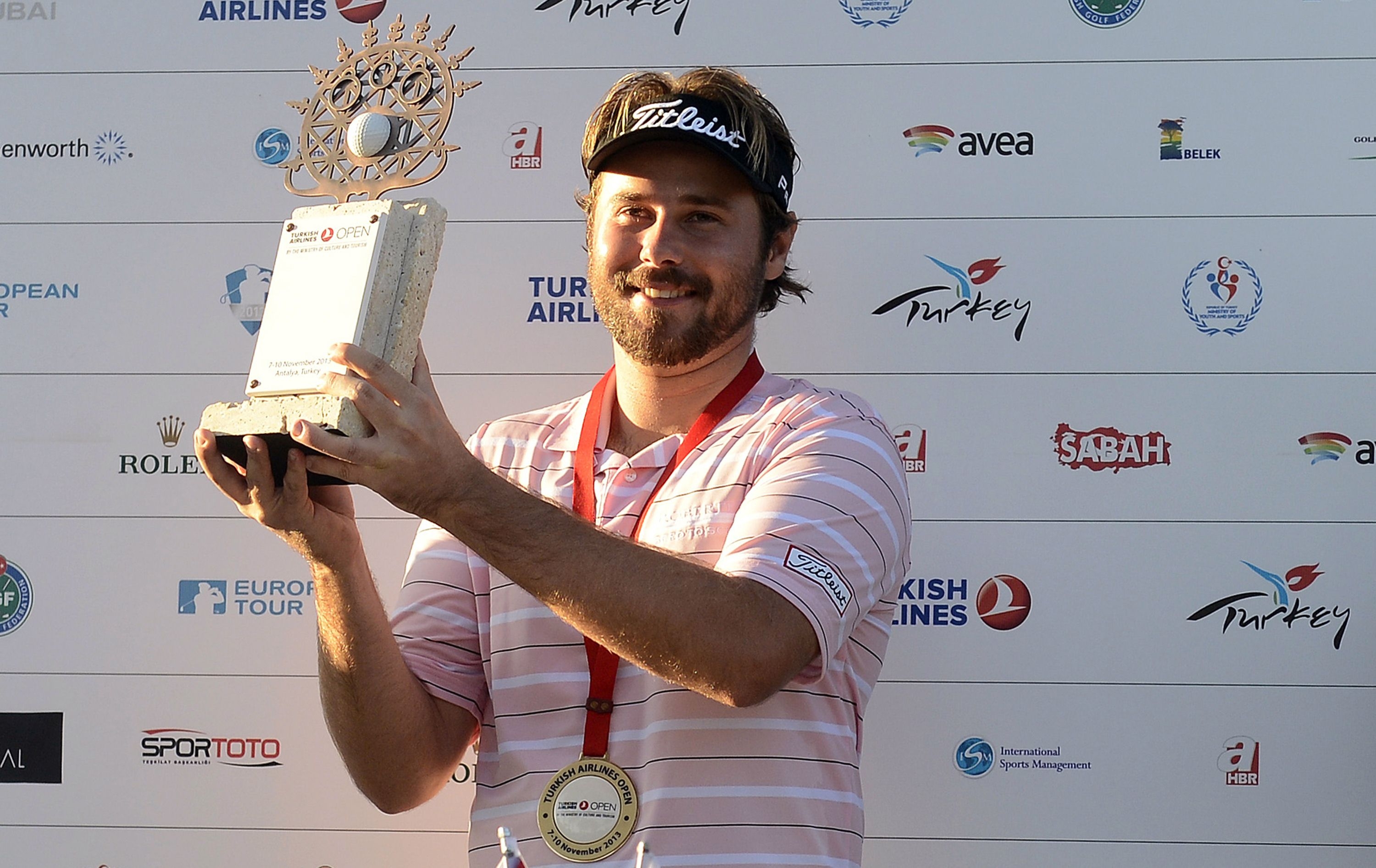 Victor Dubuisson of France poses with his trophy after winning the 2013 Turkish Airlines Open. Photo: AFP