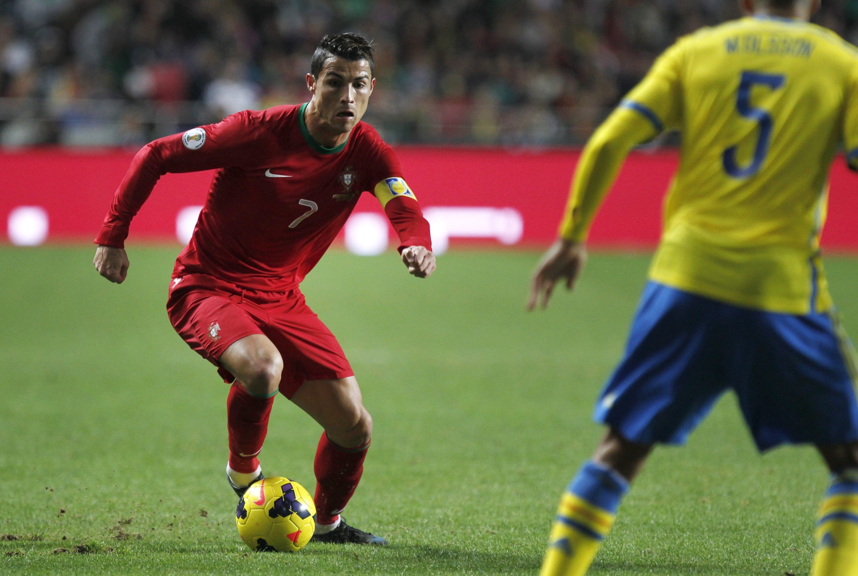 Cristiano Ronaldo runs with the ball next to Sweden's Martin Olsson, during the match between Portugal and Sweden in Lisbon. Photo: AP
