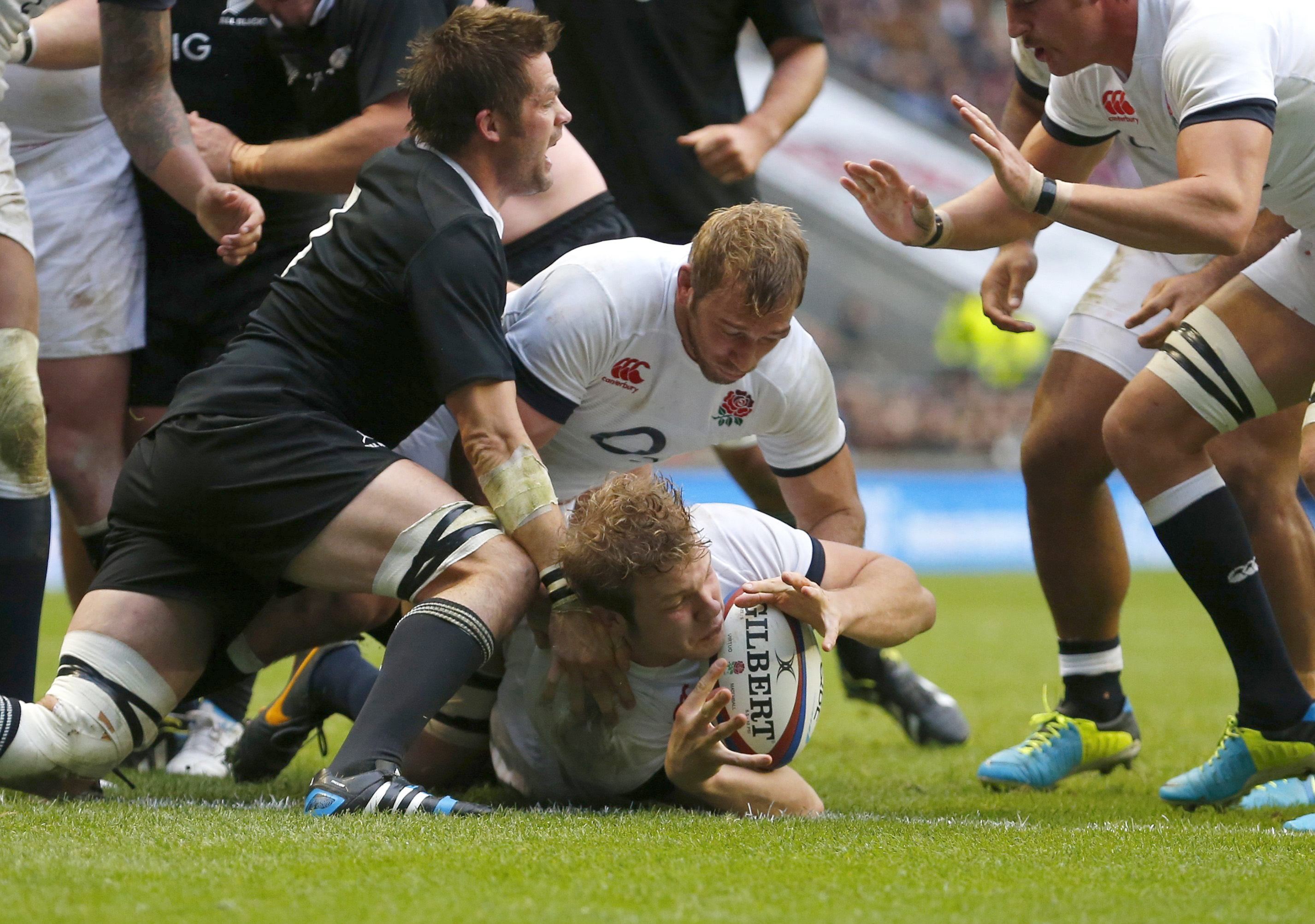All Black Richie McCaw fails to stop England's Joe Launchbury (centre) scoring a try against New Zealand. Photo: Reuters 
