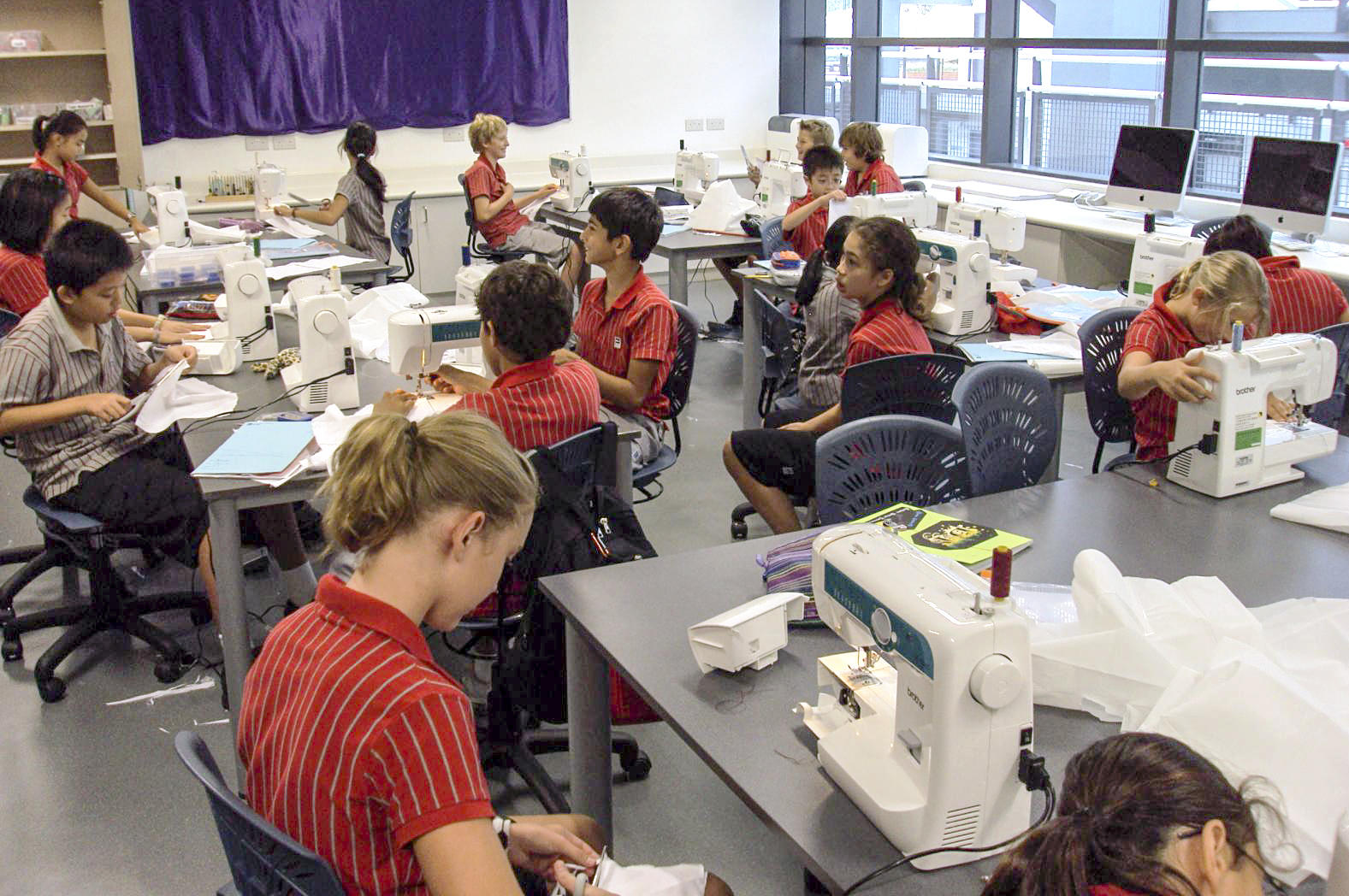 A sewing lesson at Discovery College, where parents kept tuition fees from rising. That changes next month. Photo: Dr Wesley Fryer