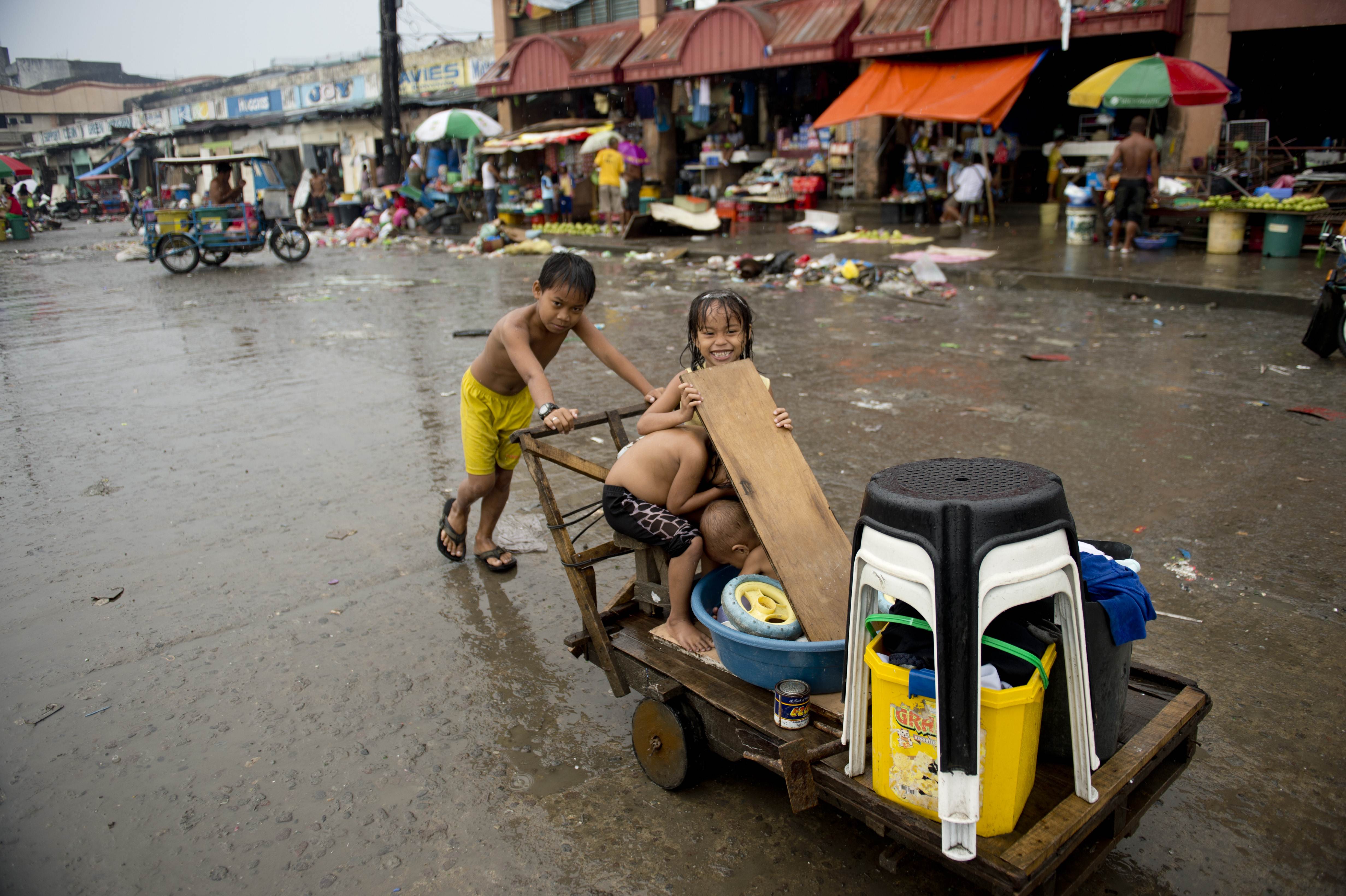 Young typhoon victims salvage reusable items in Tacloban on Saturday. Photo: AFP