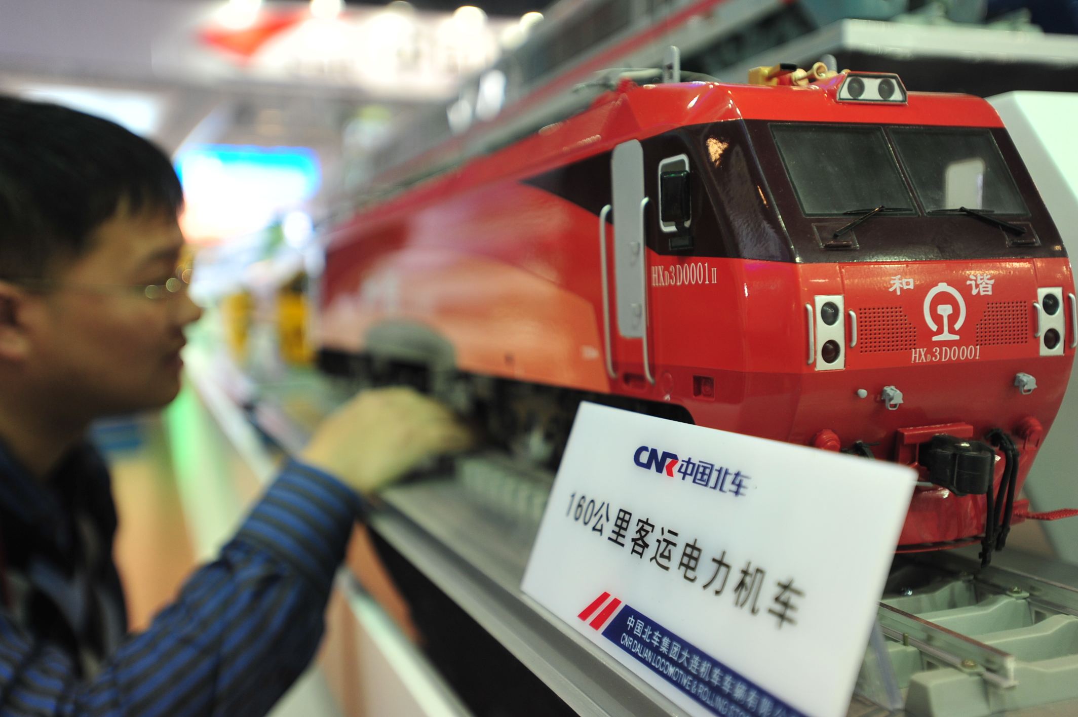 A visitor views a model of an electric locomotive made by China CNR  during an exhibition in Beijing. Photo: Xinhua