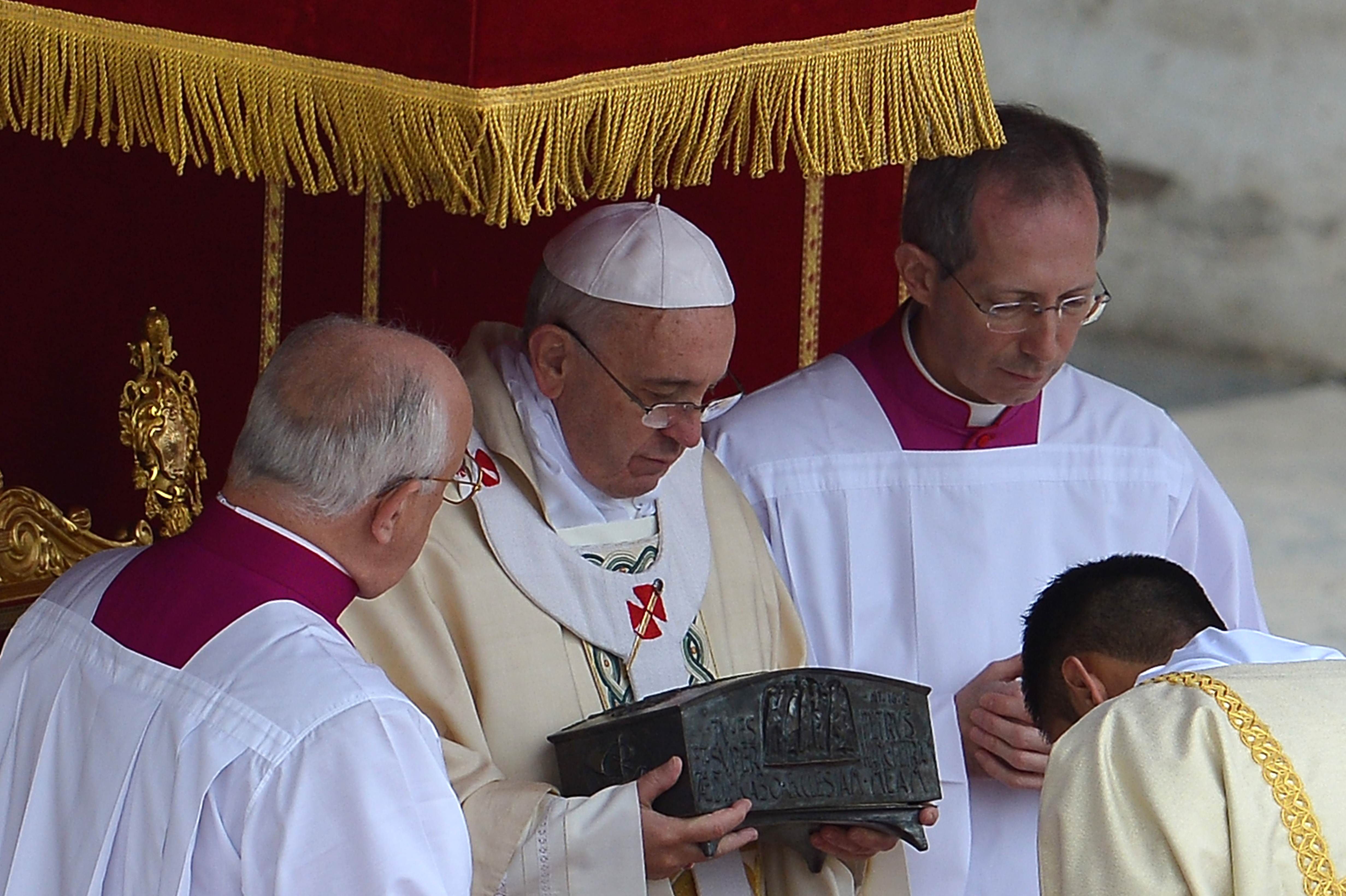 Pope Francis (centre) holds relics in St Peter's square on Sunday. Photo: AFP