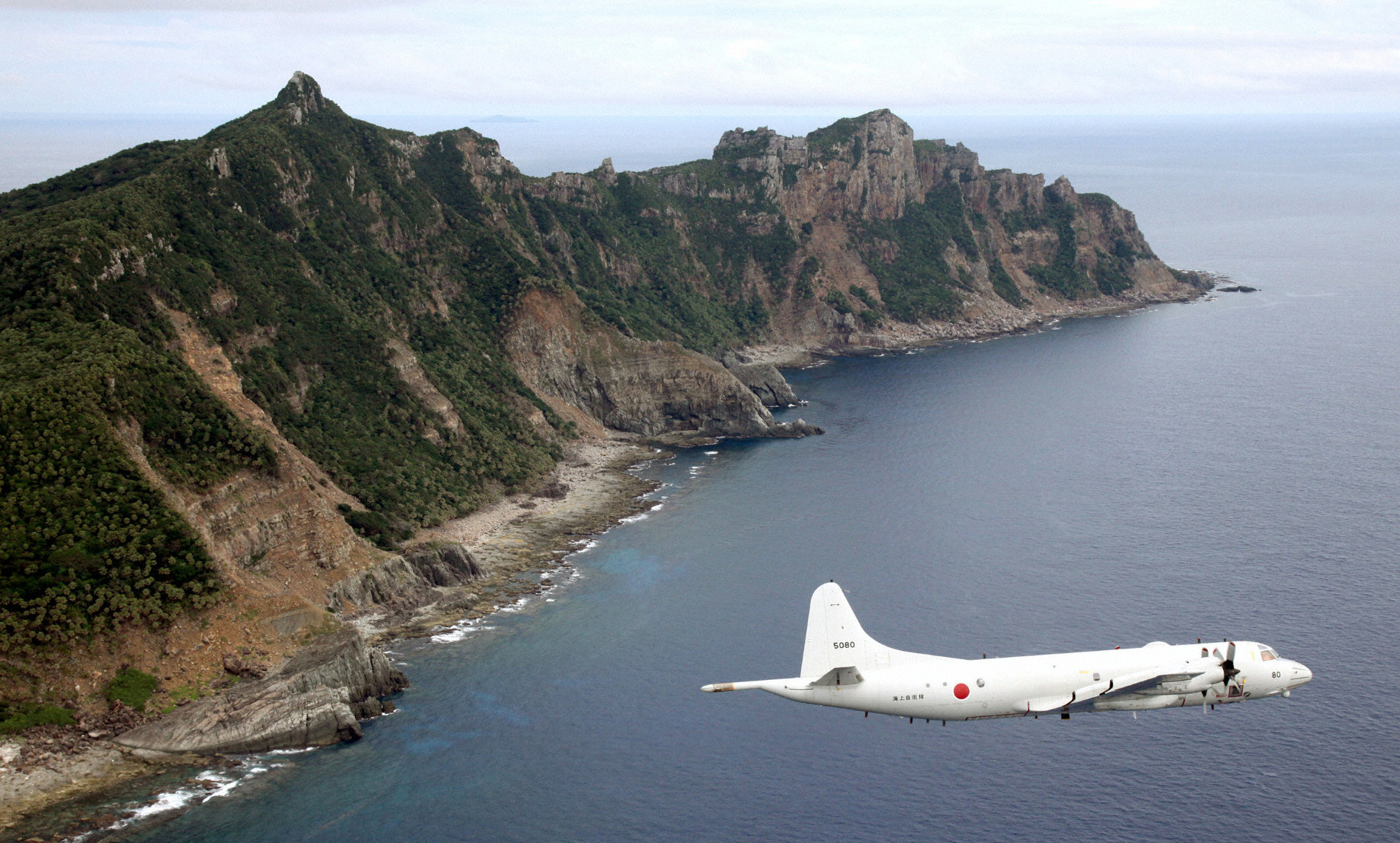 File photo of Japan Maritime Self-Defense Force's PC3 surveillance plane flying around disputed islands in the East China Sea. Photo: Reuters