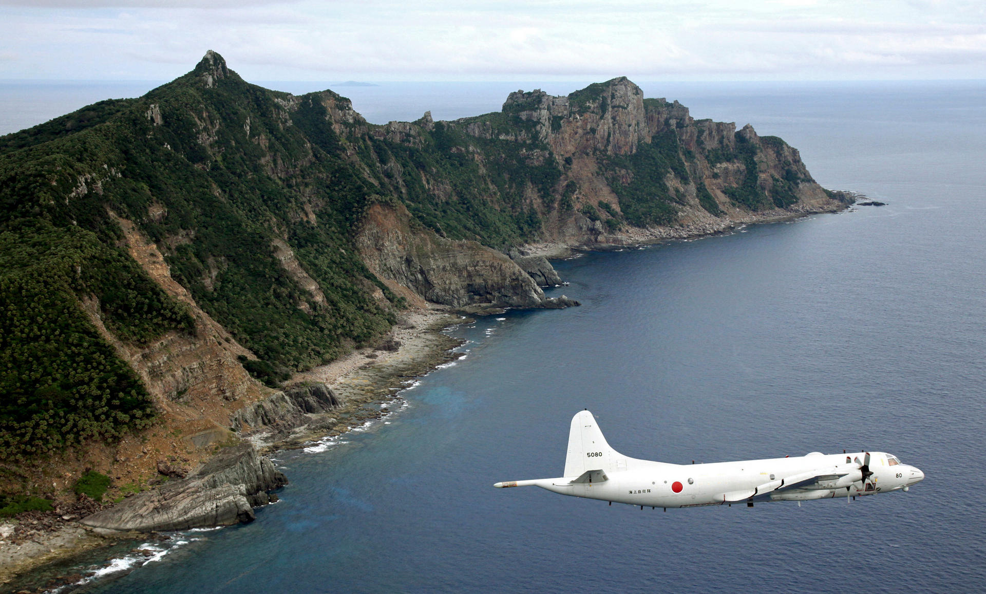 A highly sensitive issue: A Japanese military surveillance plane flies over one of the Diaoyu or Senkaku islands. Photo: AP