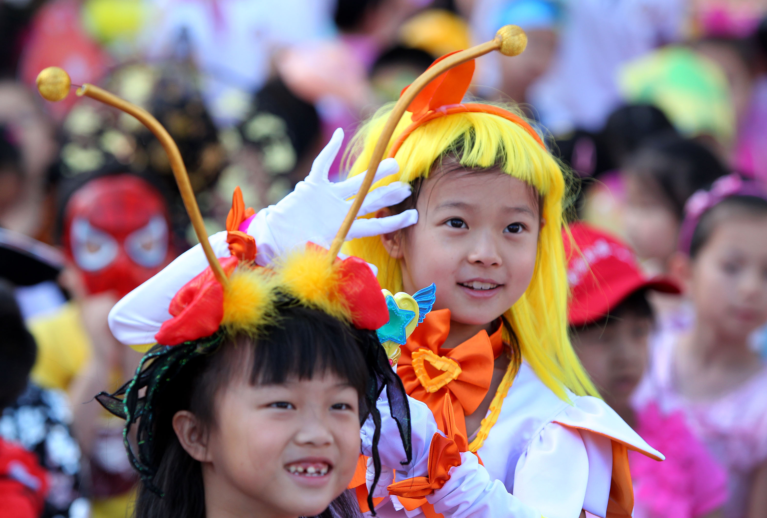 Pupils of Zhongguancun No. 1 Primary School watch performances during an art festival in Beijing on May 30, 2013.  Photo: Xinhua