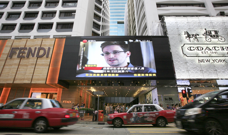 A TV screen in Central shows a report on former NSA contractor  Edward Snowden. Photo: AP