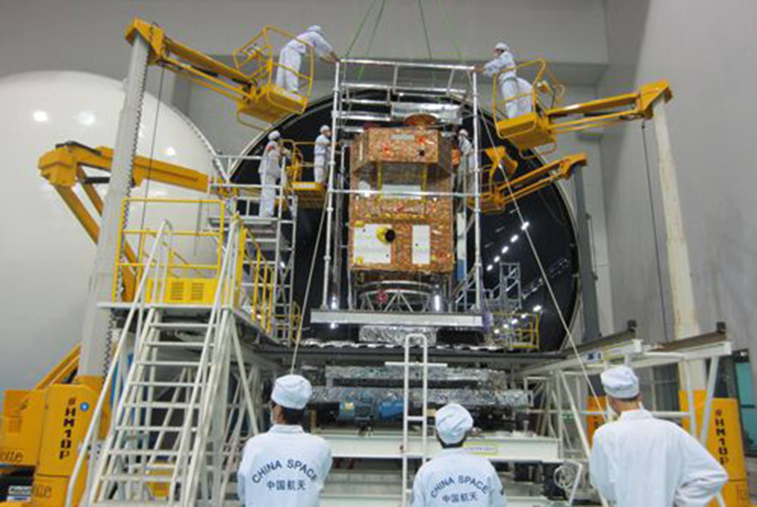 Scientists conduct tests on the satellite last year. Photo: SCMP