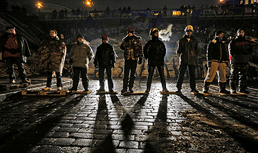 Pro-European Union activists guard barricades near the Independence Square in Kiev, Ukraine, early on Friday. Photo: AP