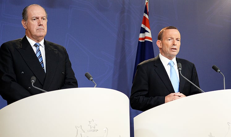Australian Prime Minister Tony Abbott (right) speaks at a press conference along with Defence Minister David Johnston in Sydney on Monday. Photo: AFP