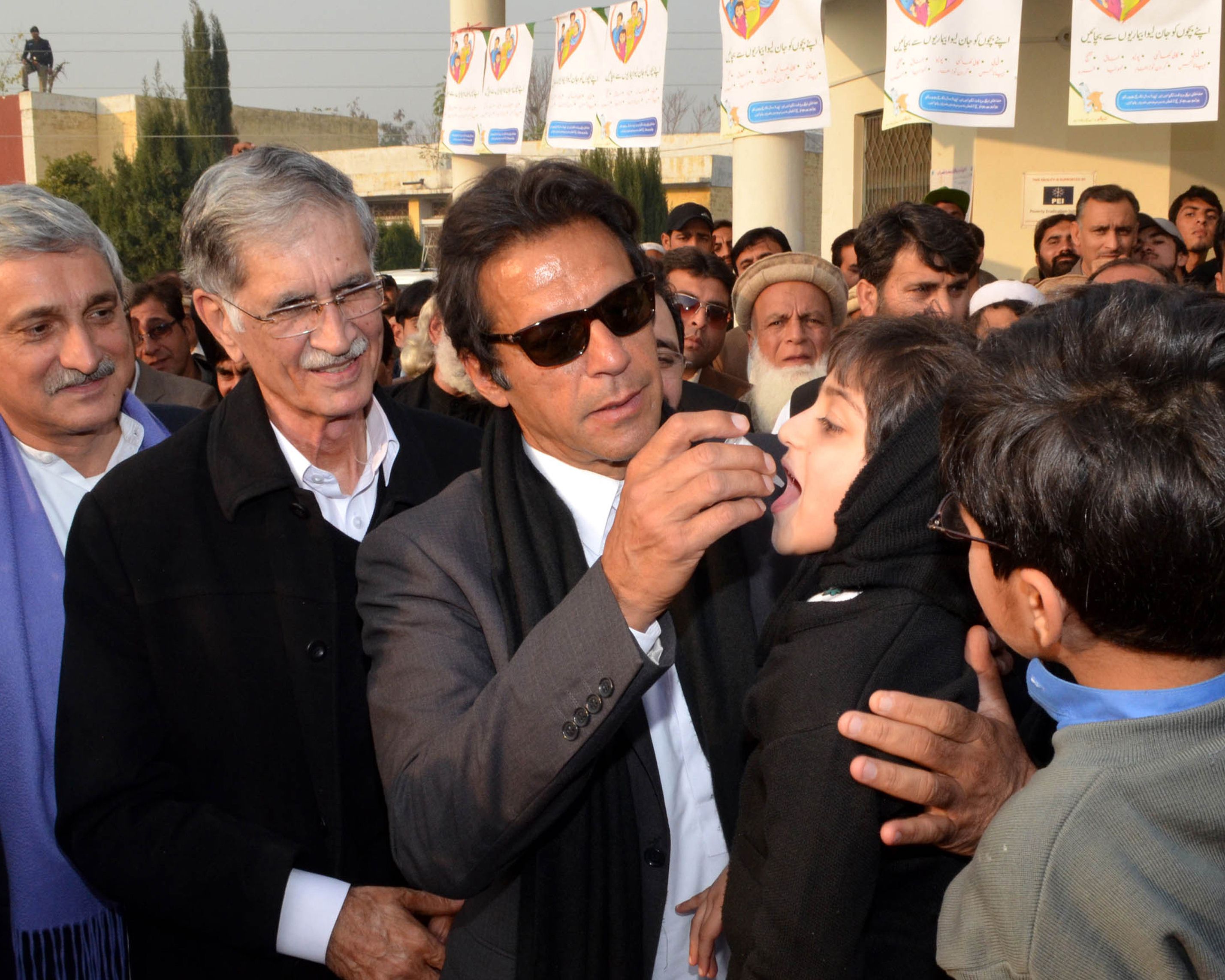 Pakistani cricketer-turned-politician Imran Khan gives polio vaccine drops to a young girl. Photo: AFP