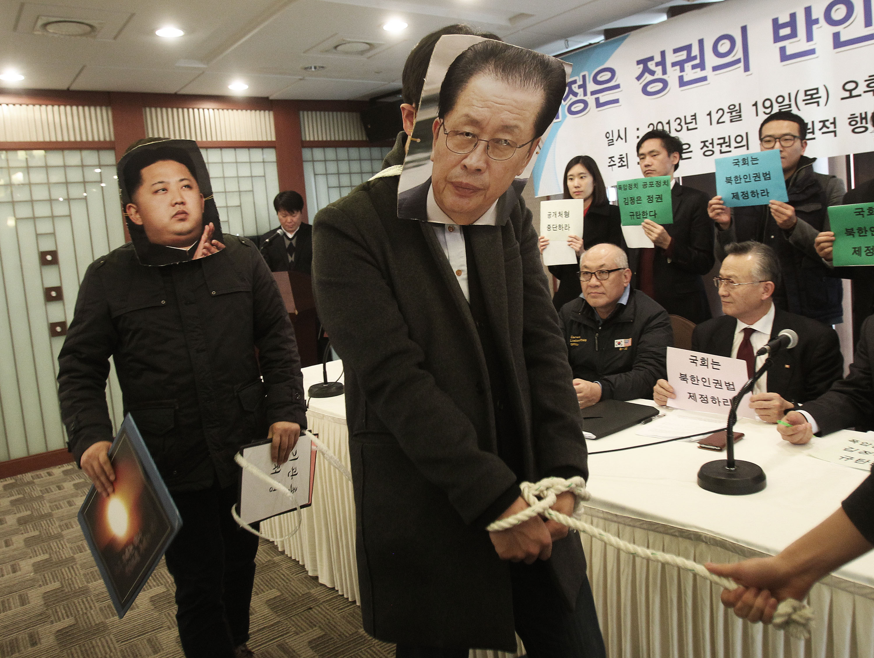 South Korean college students wearing masks of North Korean leader Kim Jong-un (left) and his uncle Jang Song-thaek are pictured during a press conference in Seoul, denouncing Kim's dictatorship and alleged human rights violations. Photo: AP.