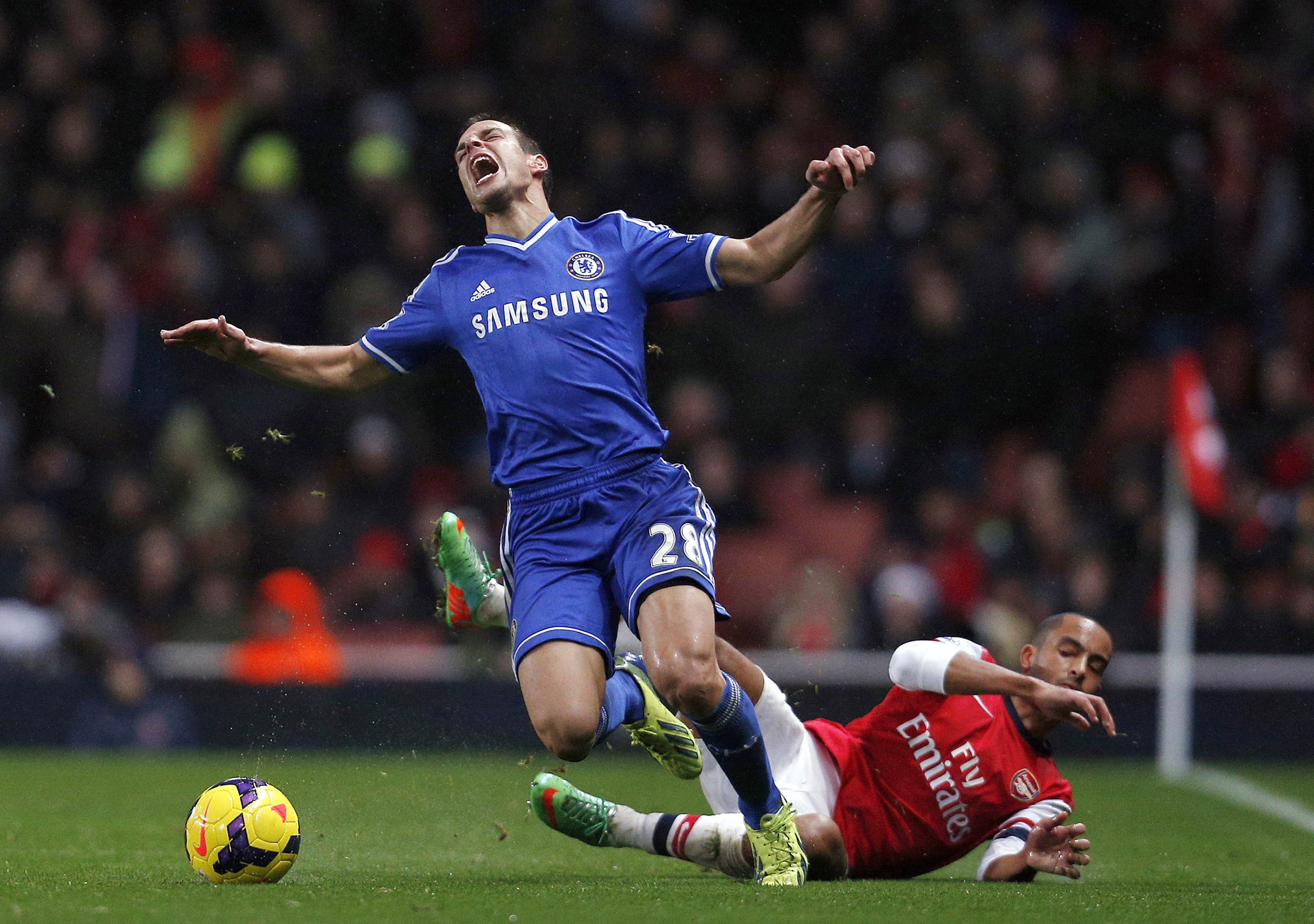 Chelsea defender Cesar Azpilicueta is tackled by Arsenal's striker Theo Walcott at the Emirates Stadium in London on Monday. Photo: AFP