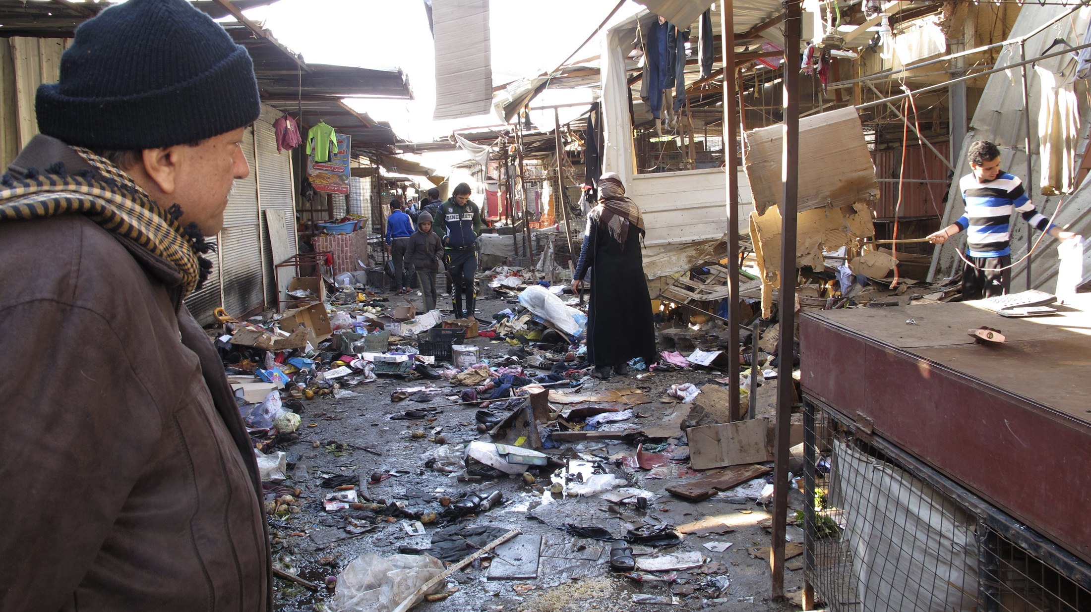 A man looks at the site of bomb attack at a marketplace in Baghdad. Photo: Reuters