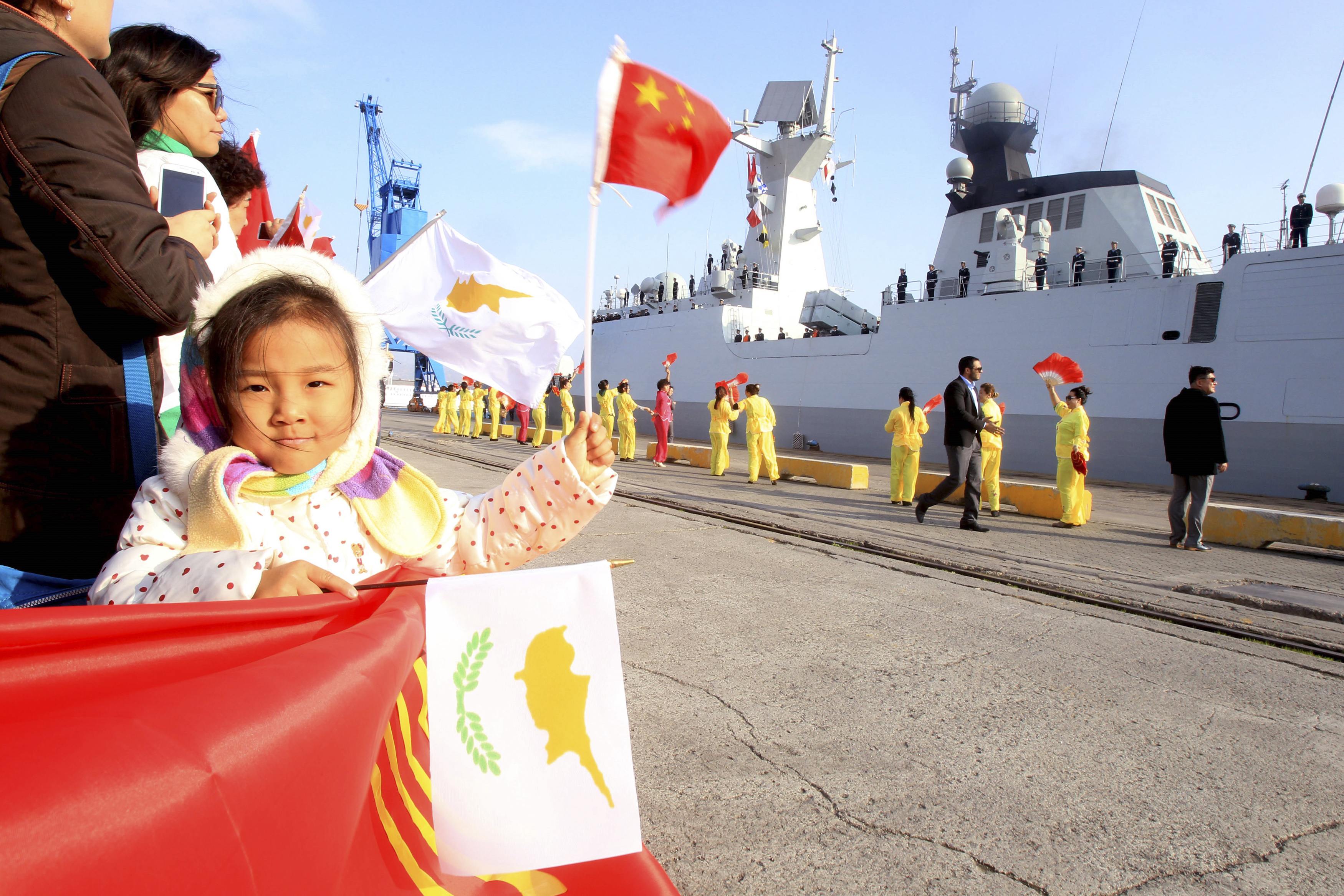 A child waves the national flags of China and Cyprus as the Chinese frigate Yancheng docks at Limassol port. Photo: Reuters