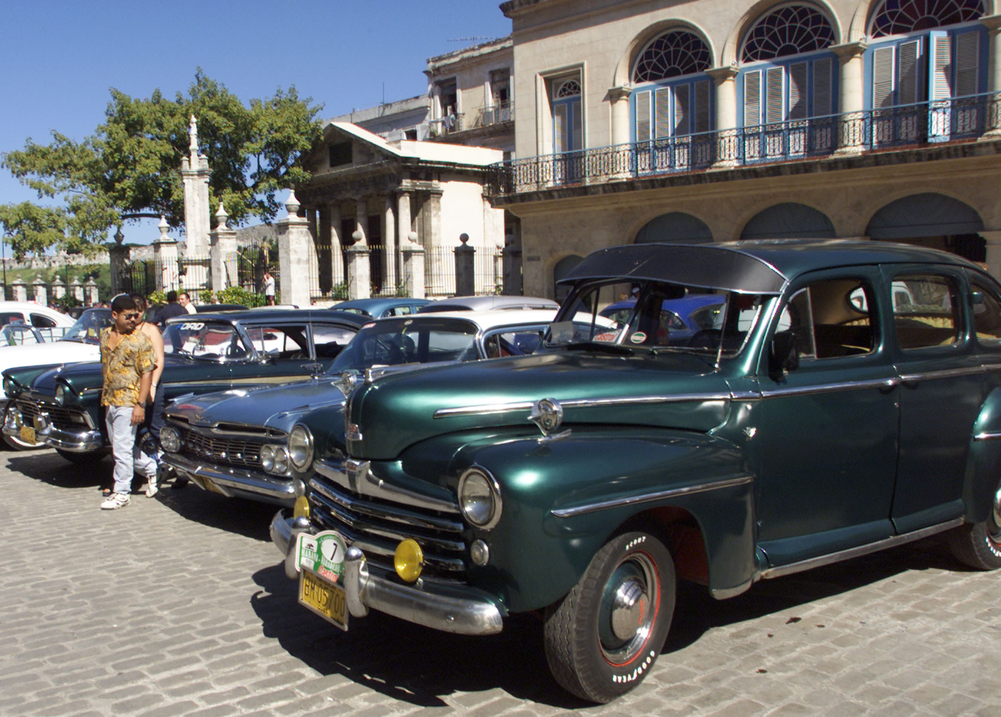 A Cuban man walks past vintage US-built cars in Havana. Photo: Reuters