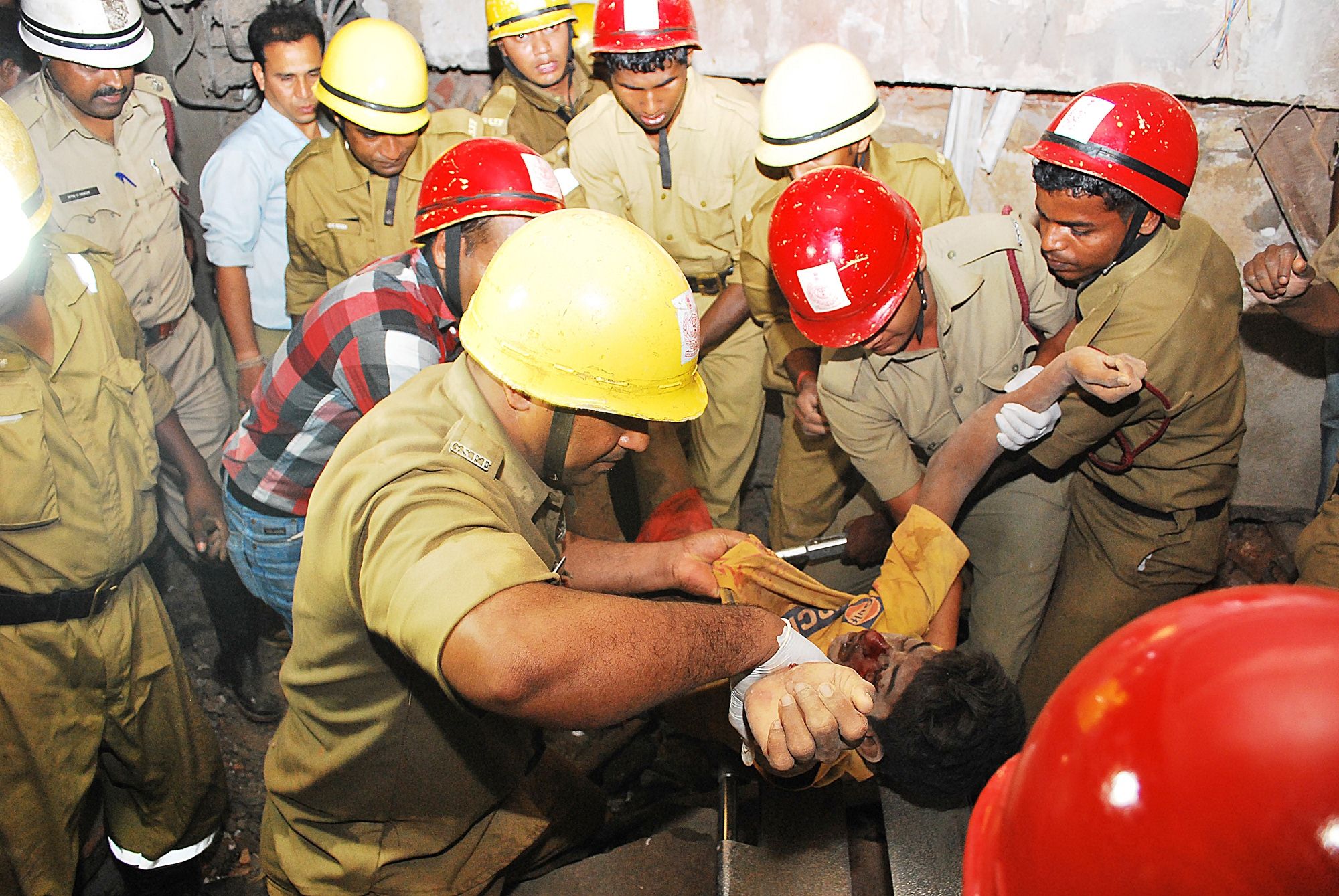 Rescue workers pull a victim from collapsed building in western Goa on Saturday. Photo: AFP 