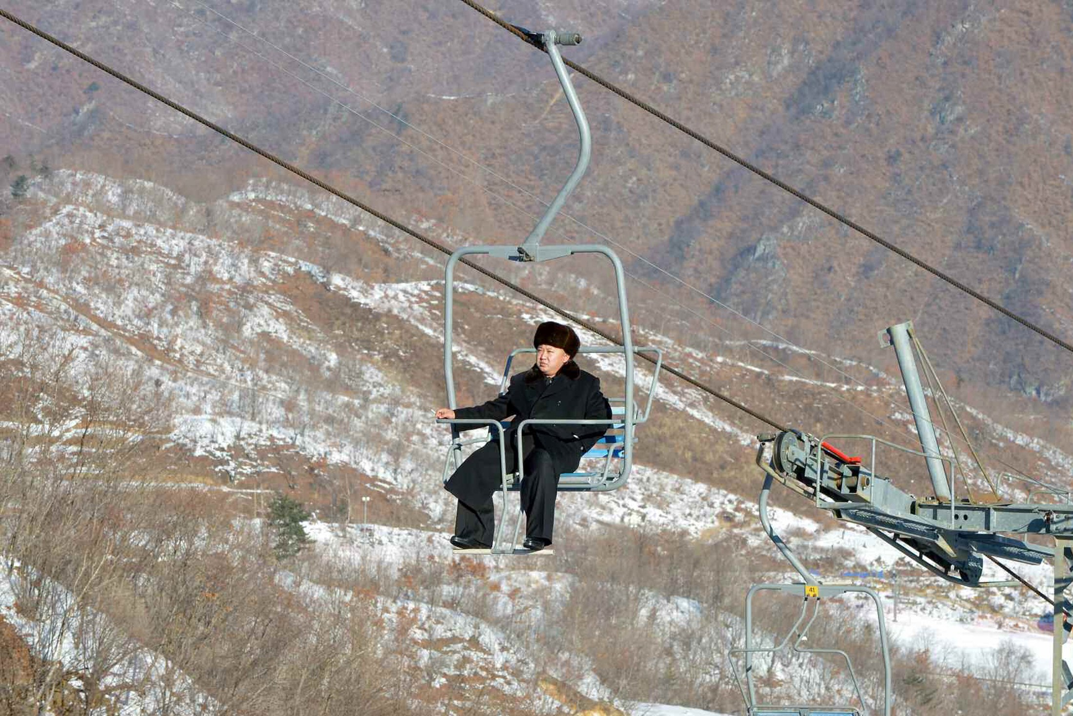 North Korean leader Kim Jong Un sits on a ski lift during a visit to a newly built ski resort in the Masik Pass region. Photo: Reuters