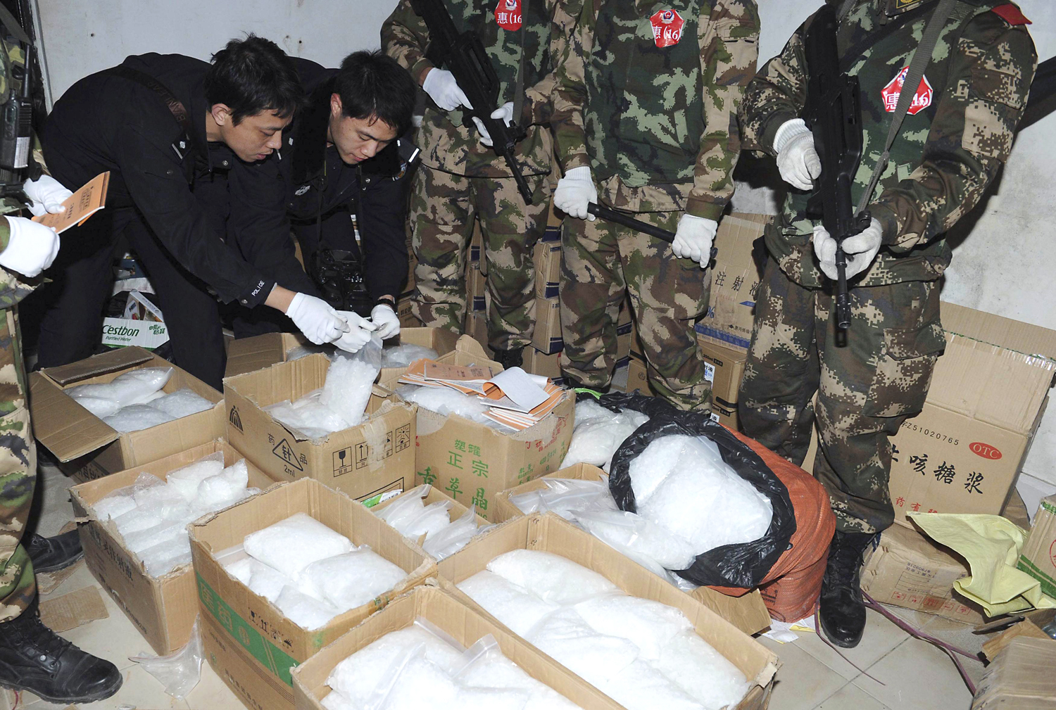Police check seized crystal meth at Boshe village in Guangdong. Photo: Reuters 