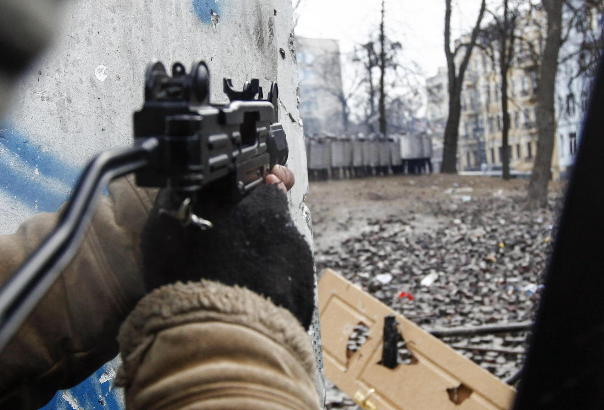 A protester aims a pneumatic gun at police in Kiev. Photo: Reuters