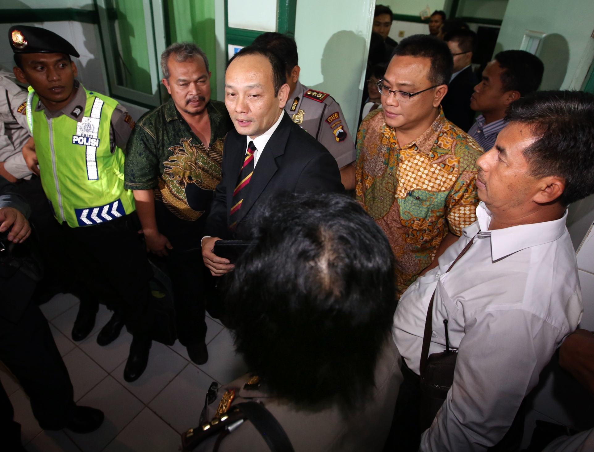 Chief inspector Chung Chi-ming (centre, with black suit) arrives at the Amal Sehat Islamic Hospital, Indonesia, to investigate Erwiana's case.  Photo: Sam Tsang