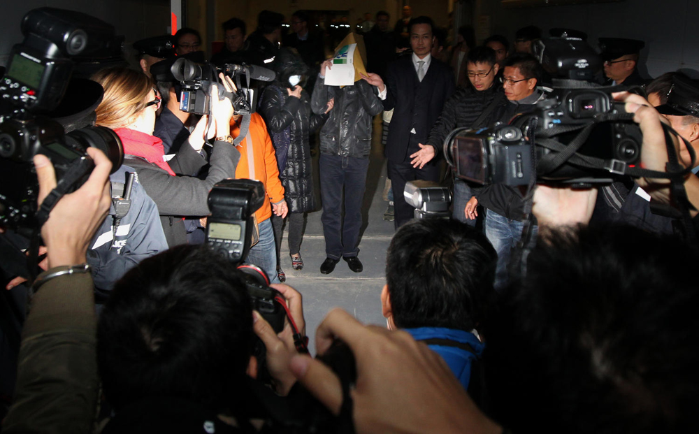 The housewife who allegedly abused her domestic helper leaves court with her husband yesterday. Photo: Nora Tam