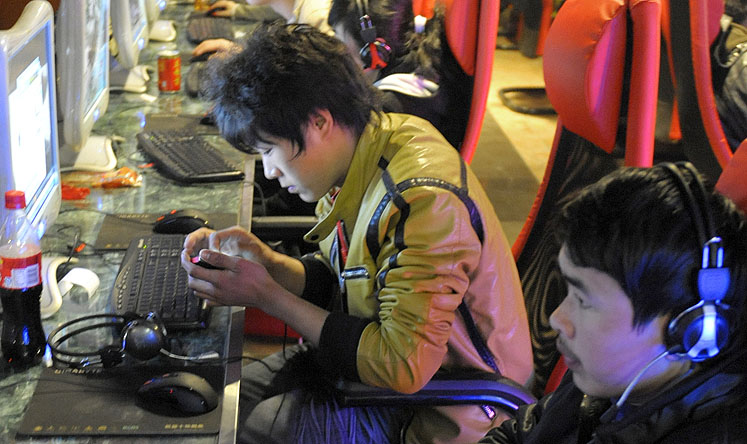 Young men at an internet cafe in Beijing. Photo: AFP