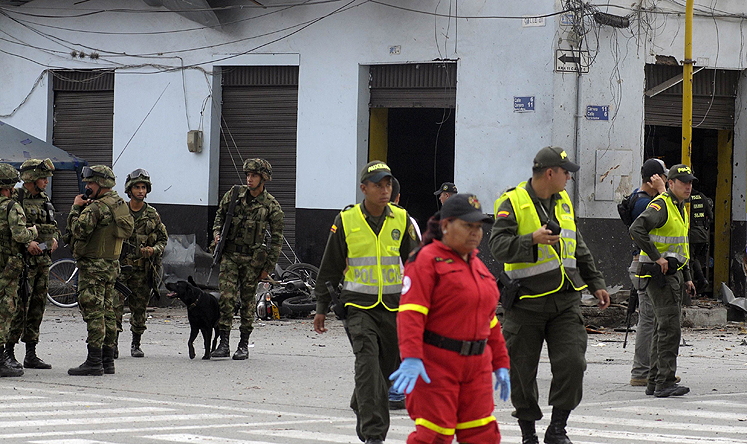 Colombian security forces inspect the site of a car bomb explosion in the Valle del Cauca region on January 16. Photo: AFP