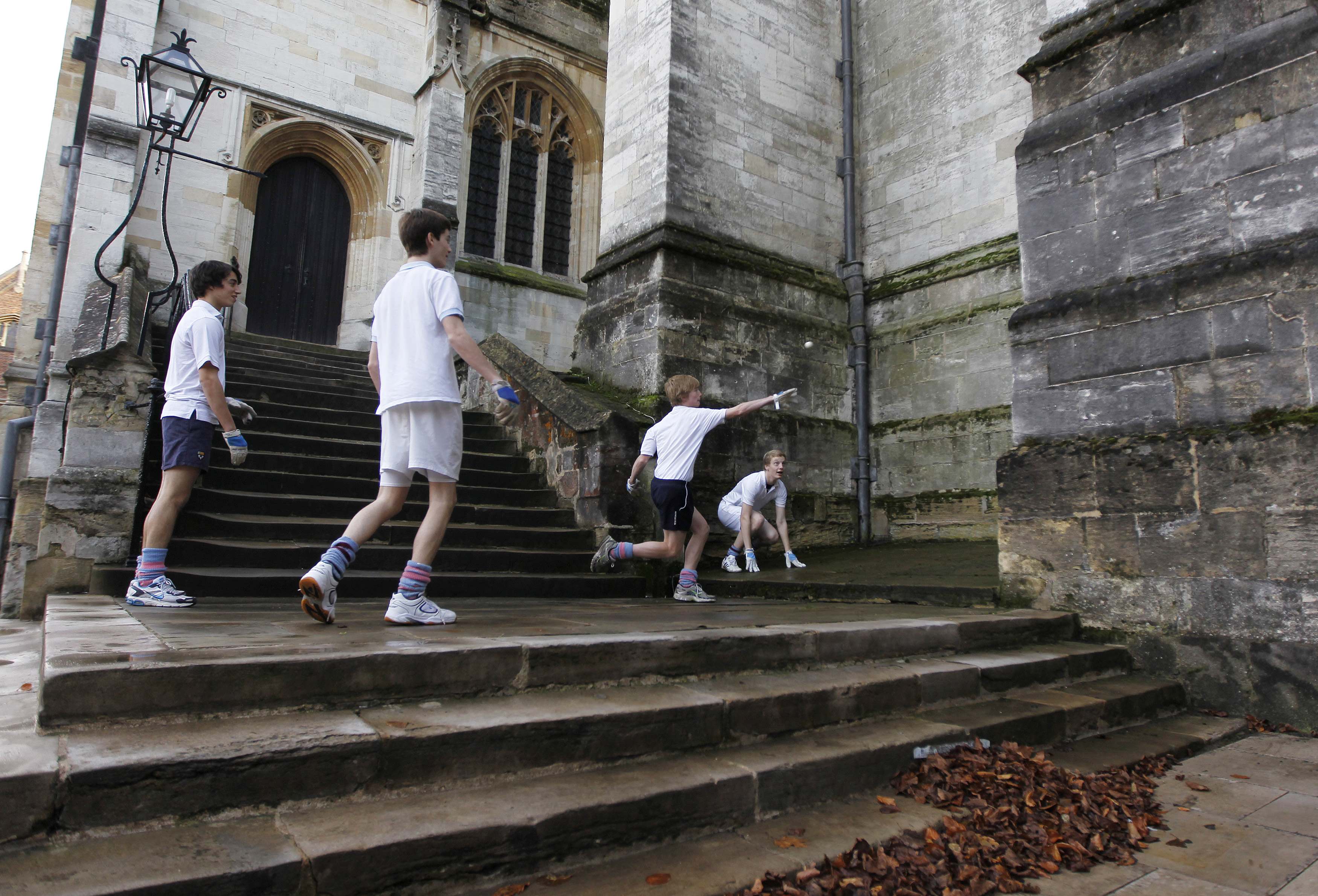 Boys from Eton college play a game of Eton Fives against the wall of the chapel in Eton, southern England. Photo: Reuters
