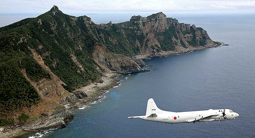 A Japanese surveillance plane flies over disputed islands in the East China Sea. Photo: AP