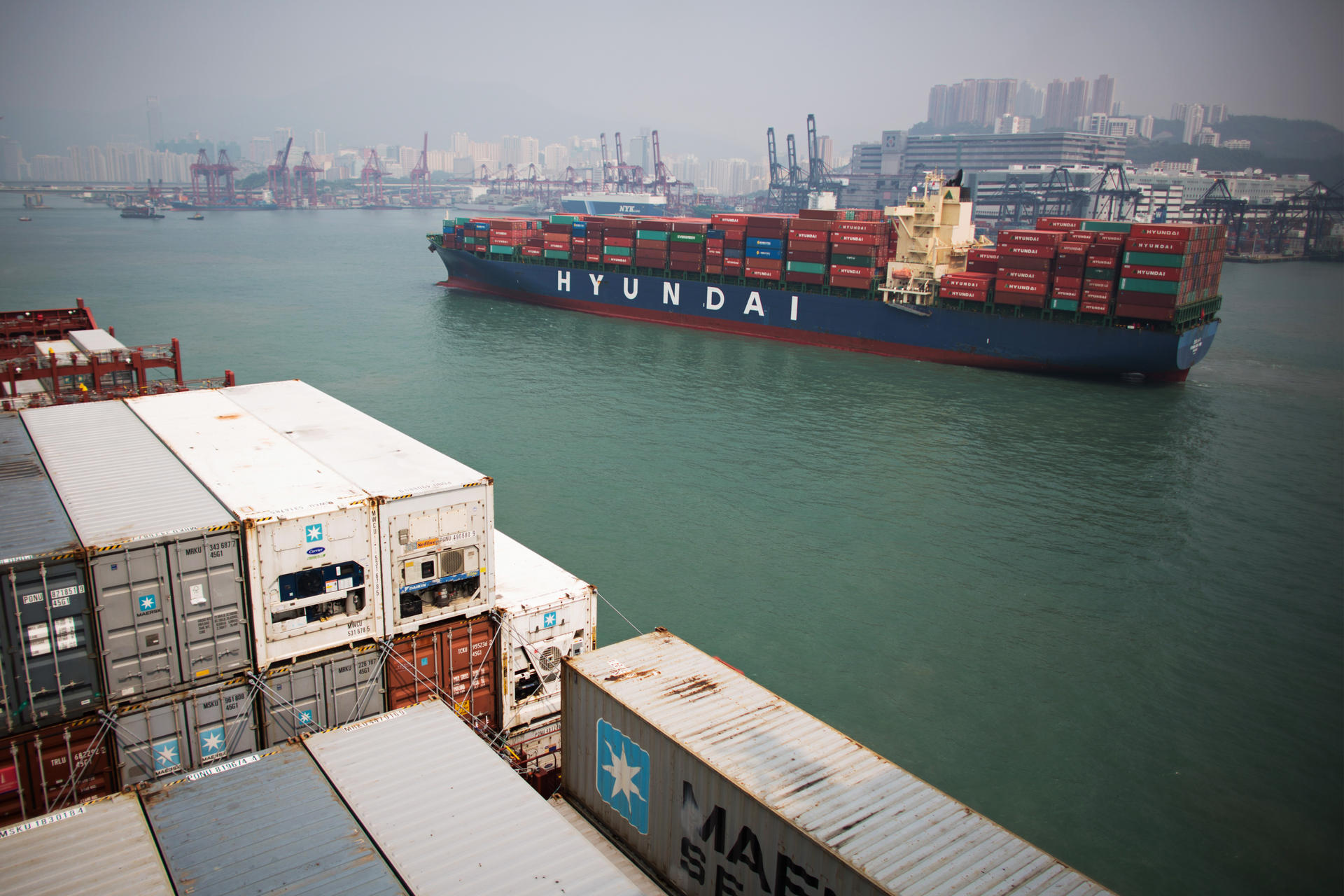 Containers are stacked aboard cargo ships in Hong Kong. The city's status as a shipping hub has eroded in recent years. Photo: Bloomberg