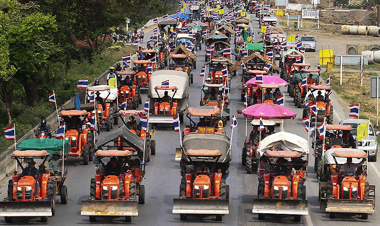 Farmers drive their tractors and other farm vehicles towards Bangkok. Photo: Reuters