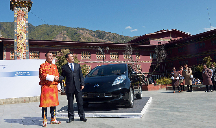 Nissan Motor Corporation chief executive officer Carlos Ghosn (centre right) and Bhutanese Prime Minister Tshering Tobgay shake hands after unveiling the Nissan Leaf electric vehicle in Thimphu on Friday. Photo: AFP