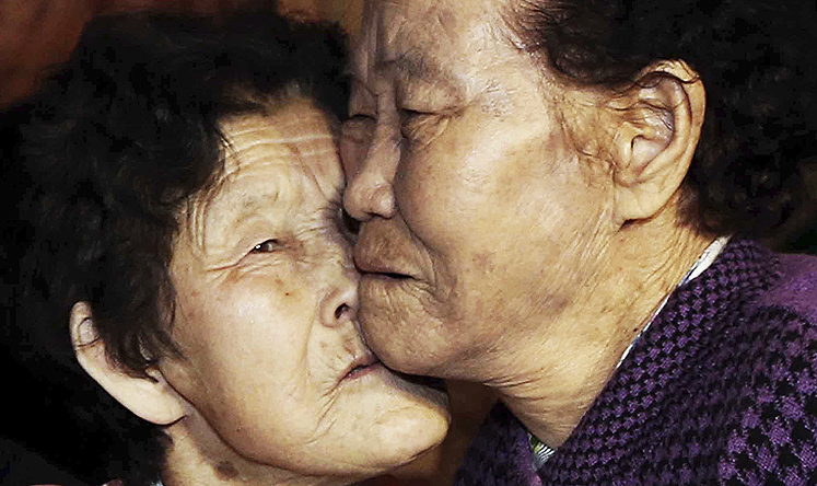 South Korean Lee Chun-hwa, 84, (right), gets a kiss from her North Korean sister Lee Chun-son at a family reunion in the North Korean Diamond Mountain resort on Saturday. Photo: AP