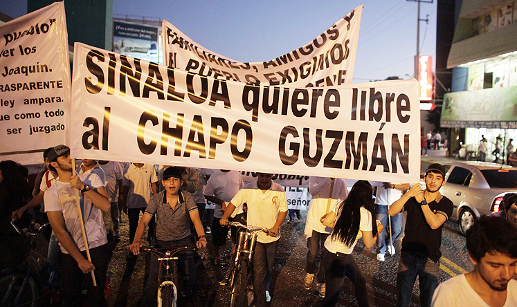 Protesters carry a sign reading, 'Sinaloa wants Chapo Guzman free' during a march in Culiacan on Wednesday. Photo: Reuters