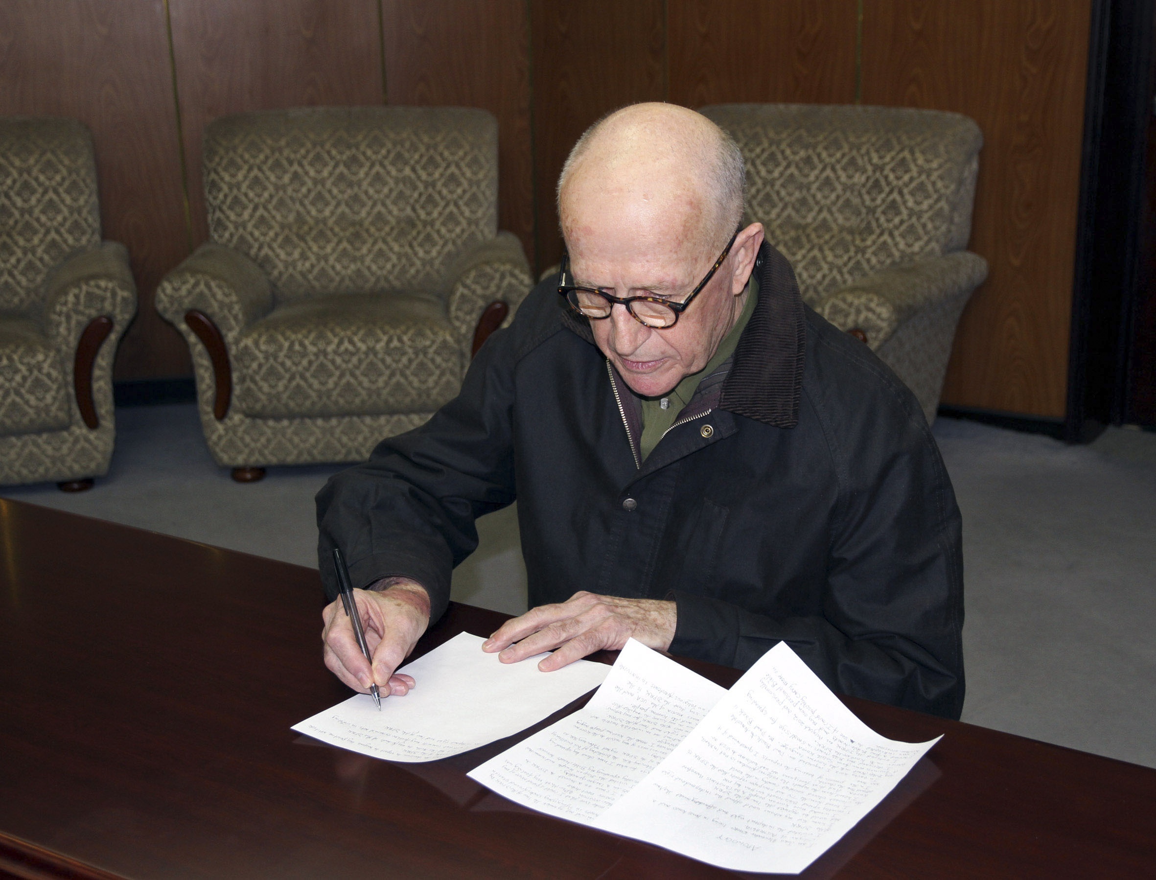 The state-run KCNA news agency released this photo of Short signing a written confession. Photo: KCNA / Reuters