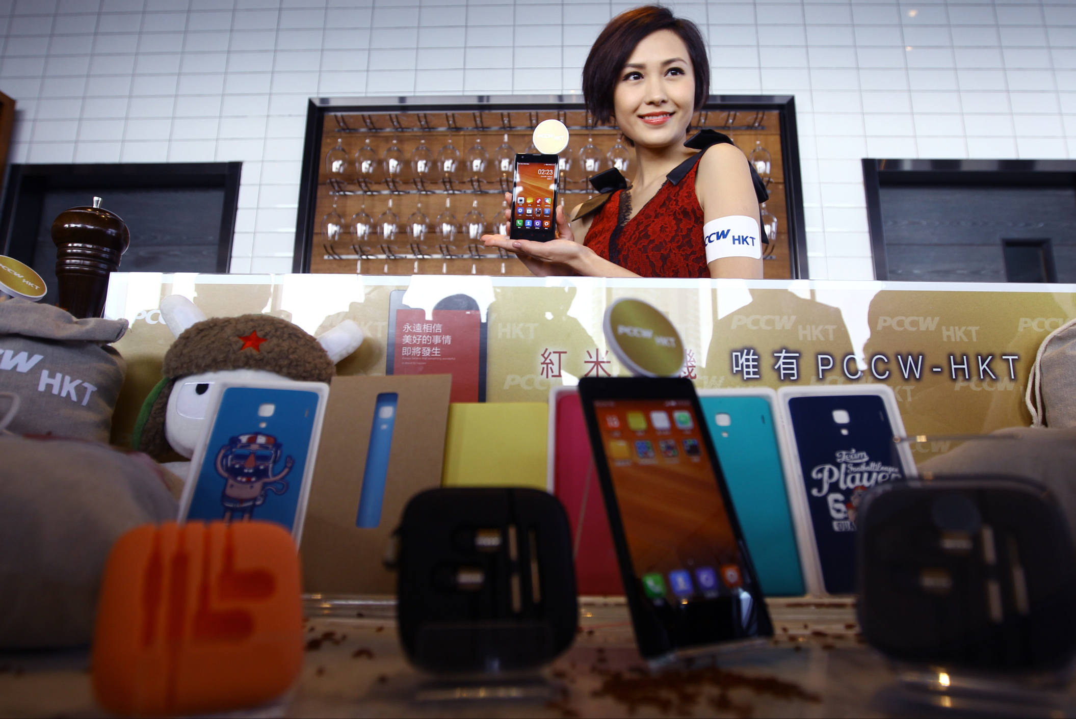A model pictured with a display of Xiaomi Hongmi smartphones at a PCCW-HKT luncheon to announce they will be the first Hong Kong dealer for the Beijing based smartphone. Photo: Jonathan Wong