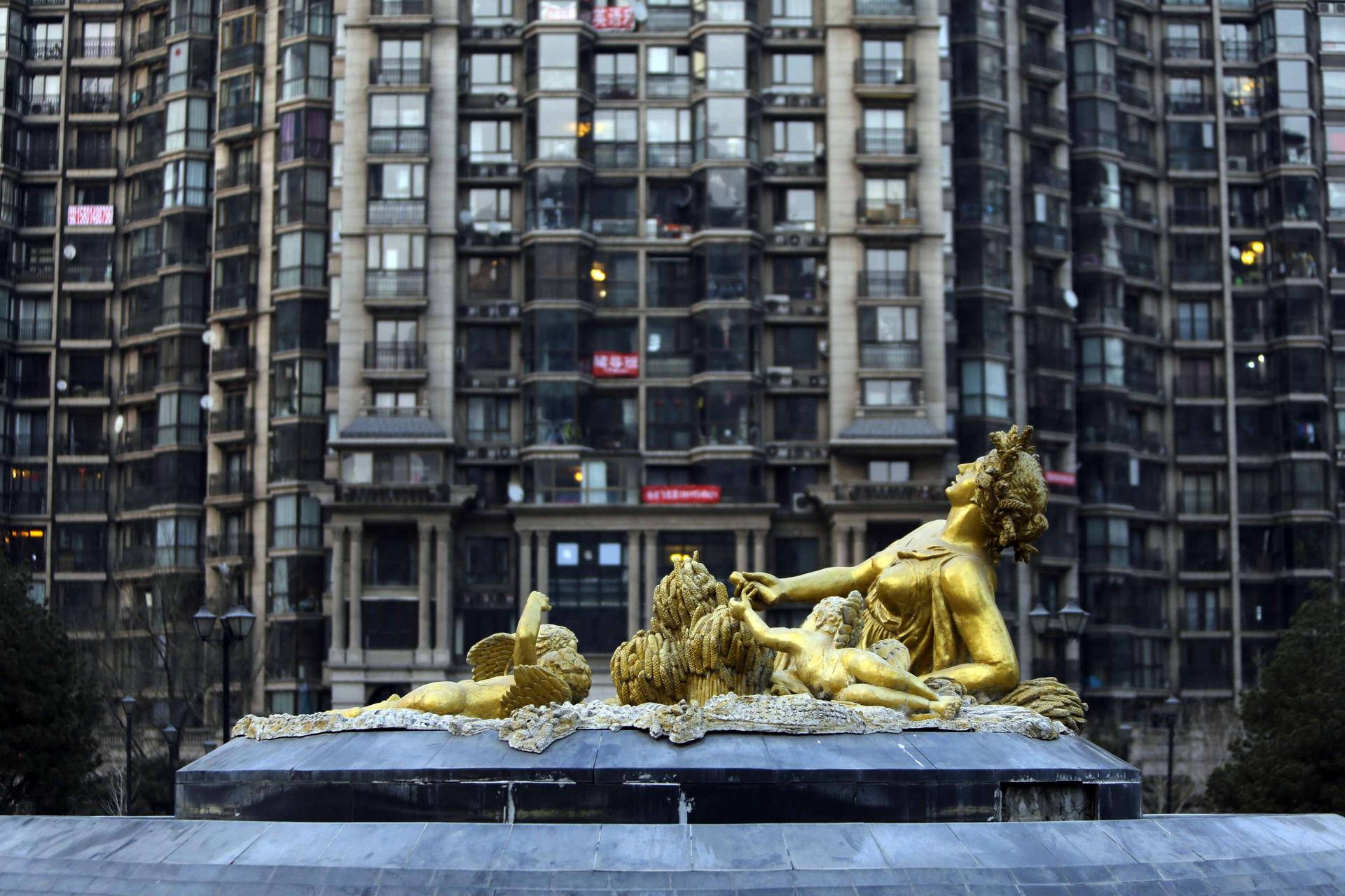 A sculpture in front of a Beijing tower block - Premier Li Keqiang signalled a different approach from his predecessor's battle to control the property market. Photo: Reuters