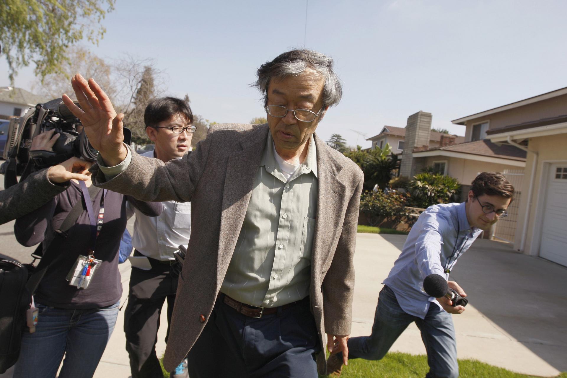 Satoshi Nakamoto, reportedly the creator of the virtual currency bitcoin, is followed by eager reporters as he leaves his home in California on Thursday. Photo: Reuters