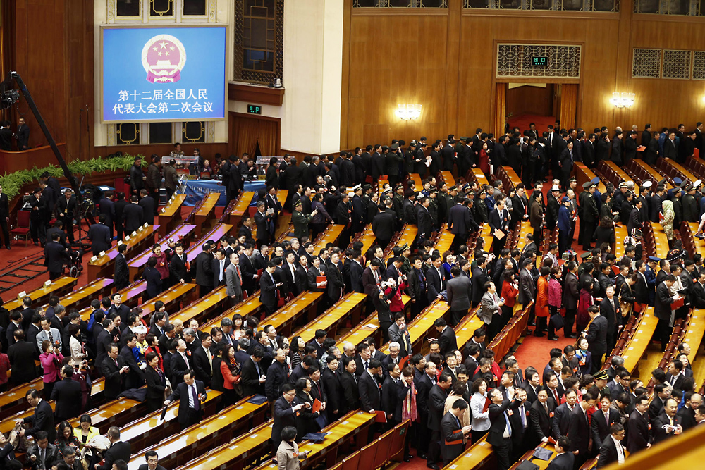 Lawmakers depart following the closing ceremony of the National People's Congress in Beijing. Photo: AP
