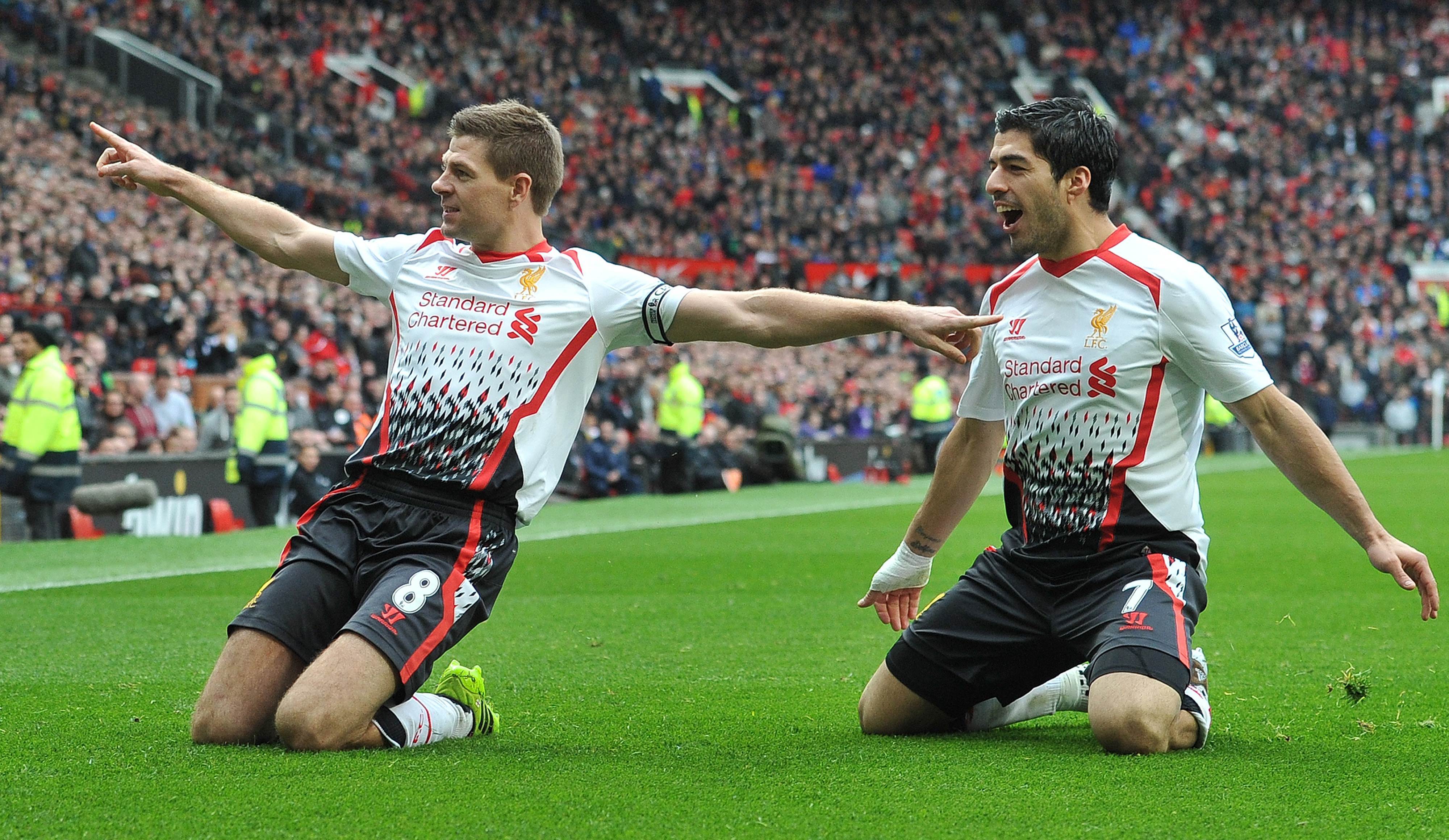 Liverpool midfielder Steven Gerrard celebrates with Uruguayan forward Luis Suarez after scoring his team's second goal during their English Premier League match with United at Old Trafford. Photo: AFP 